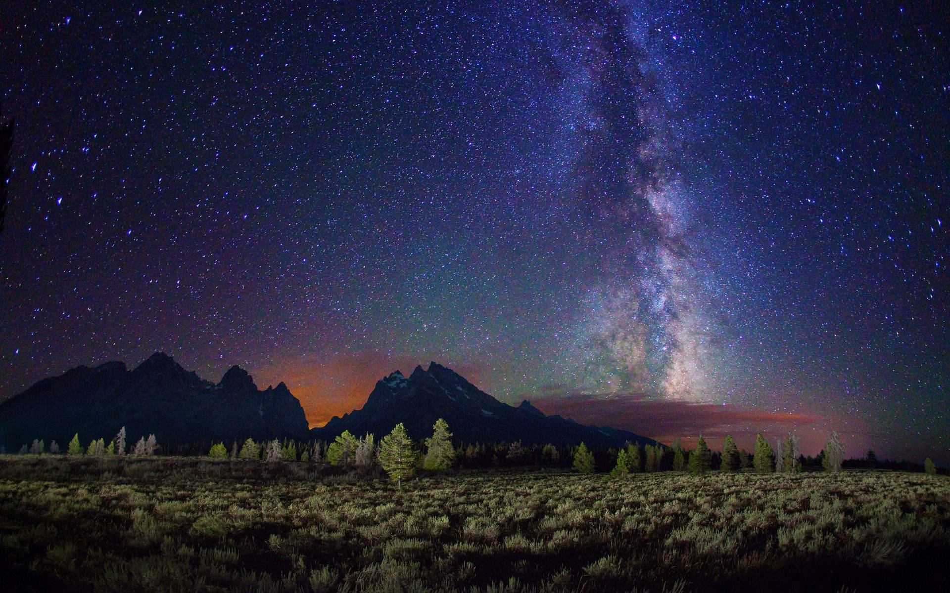 The Milky Way Over A Mountain Range Background