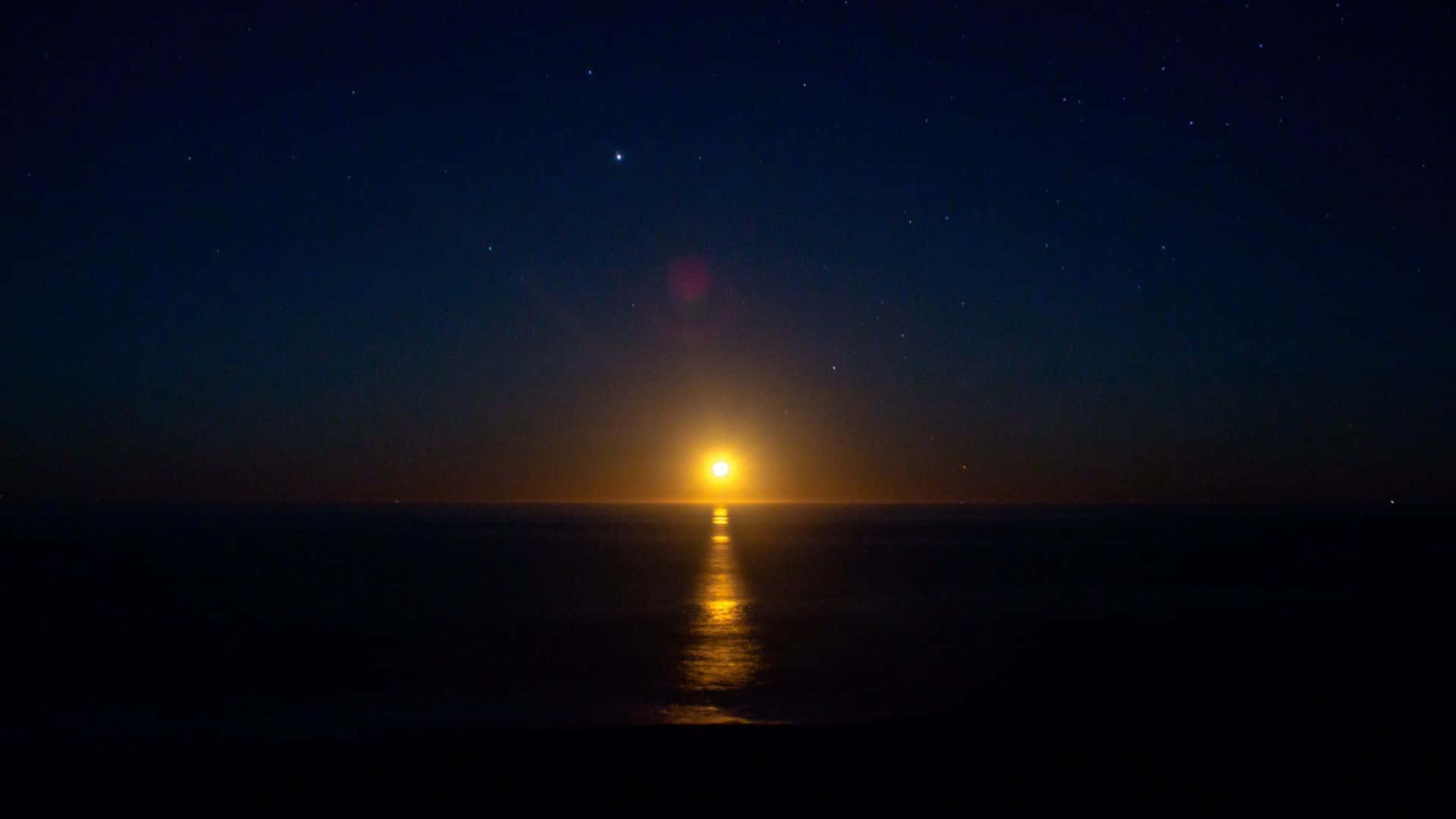 The Moon Is Rising Over The Ocean Background