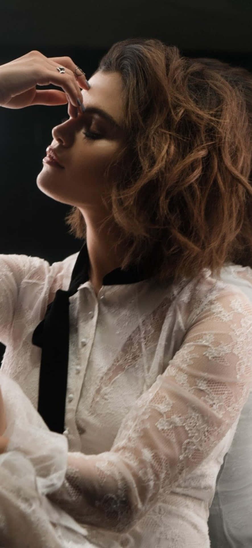 The Multi-talented Selena Gomez Styled In Her Signature Look, With Her Coveted Iphone Model. Background
