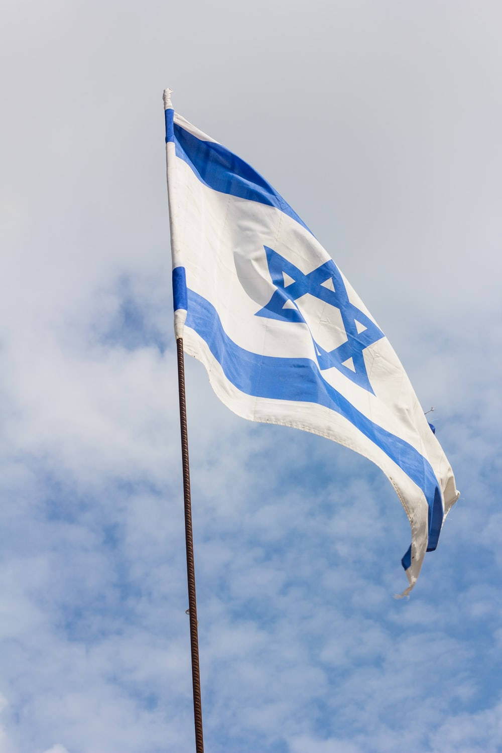 The National Flag Of Israel Proudly Displayed On A Metal Rod Background