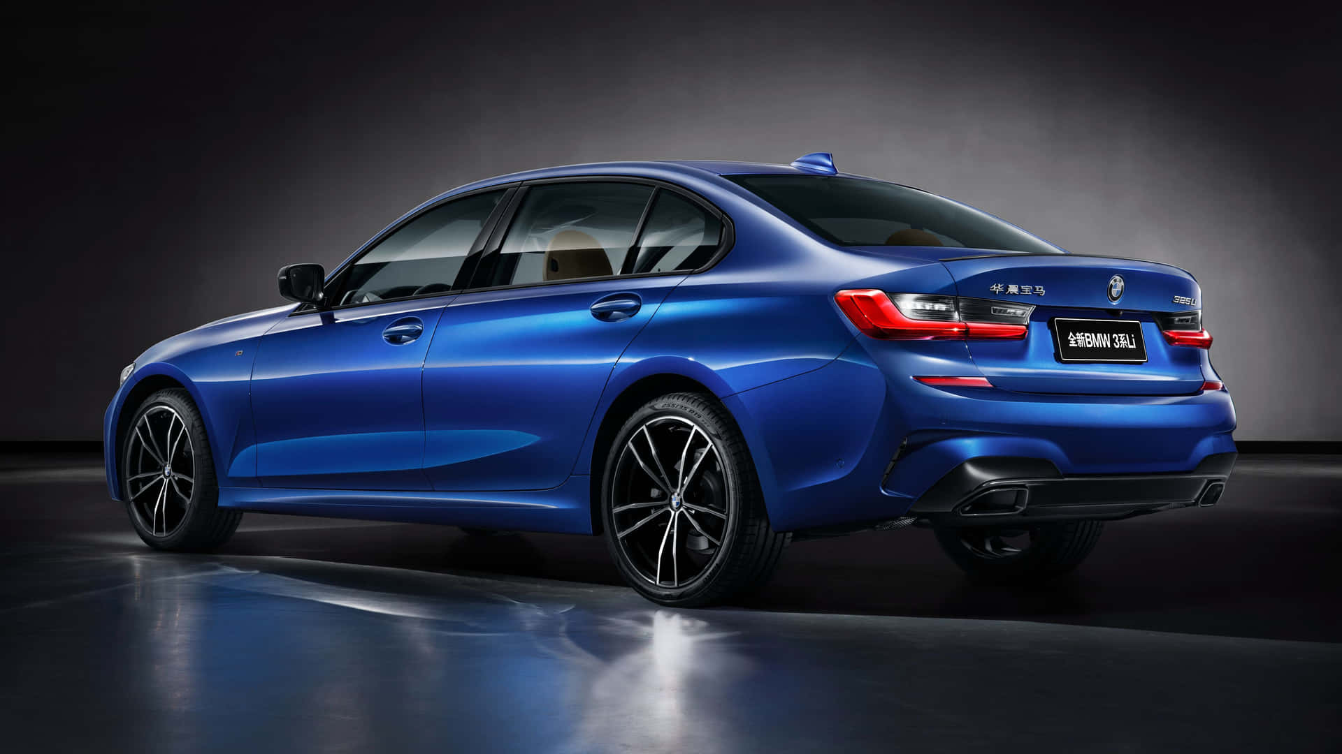 The New Bmw 3 Series Sedan Is Shown In A Dark Room Background