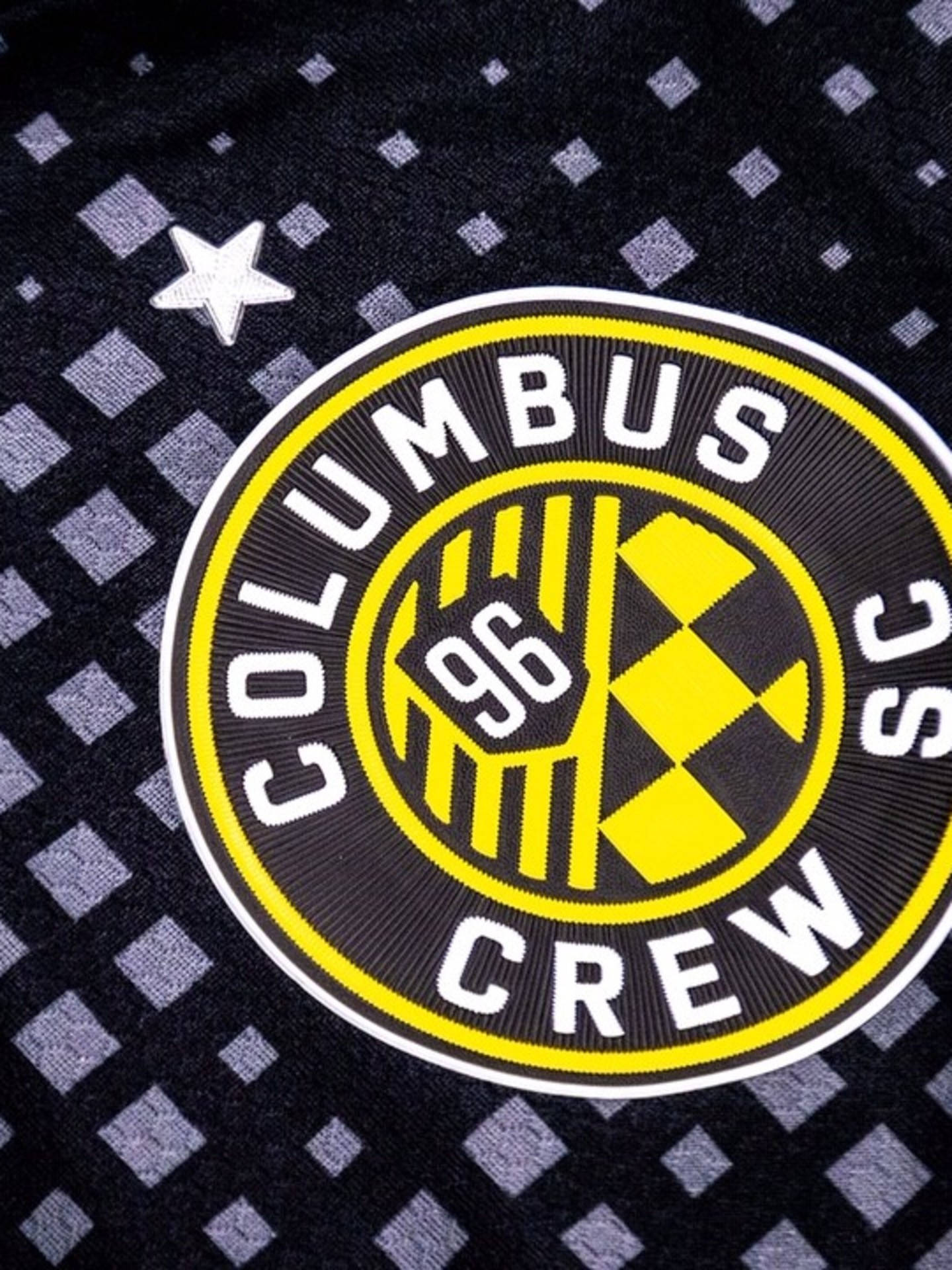 The New Logo Of Columbus Crew In A Stylish Black Background