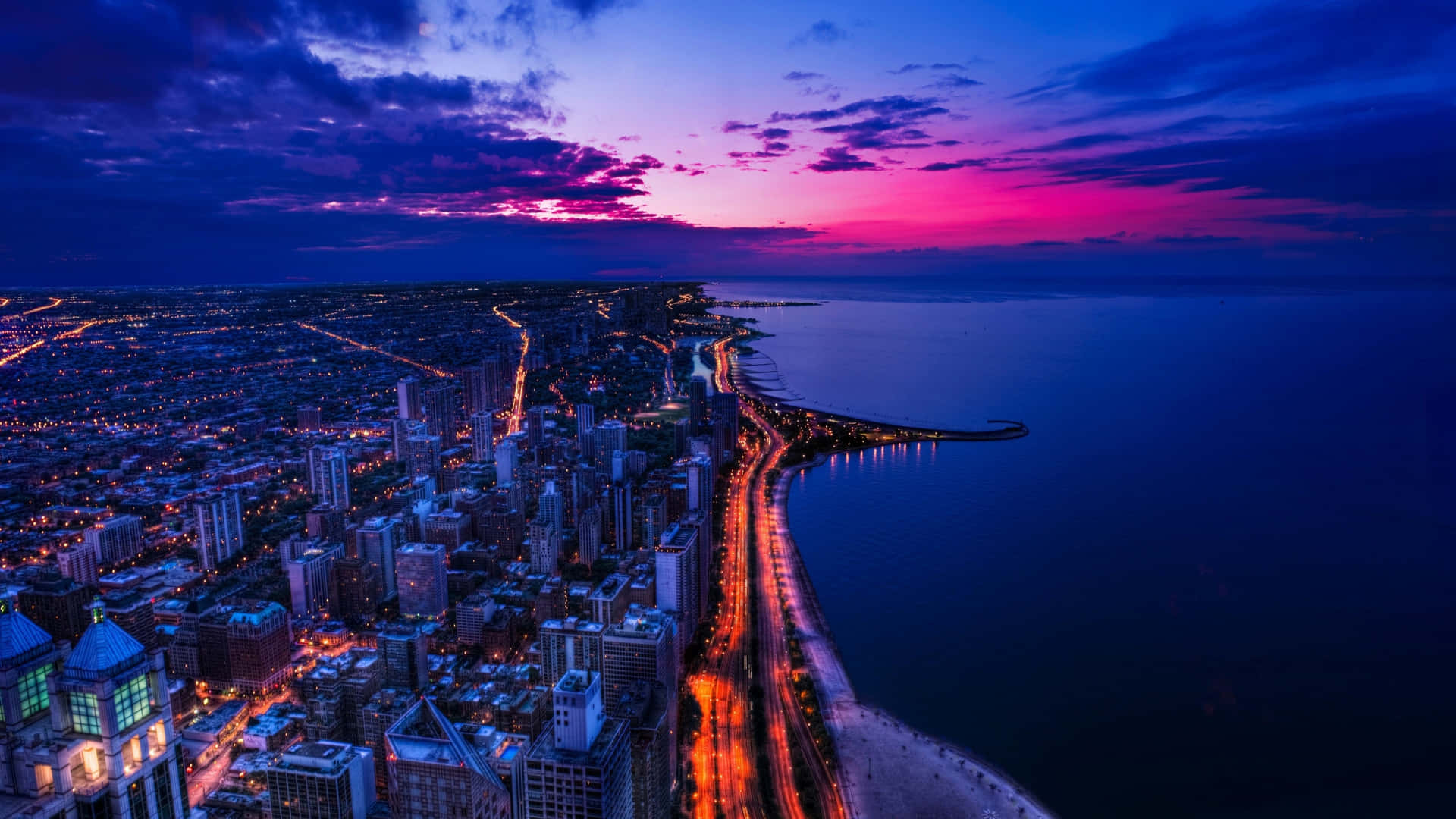The Night Sky Tremendously Lights Up A Vast City Background