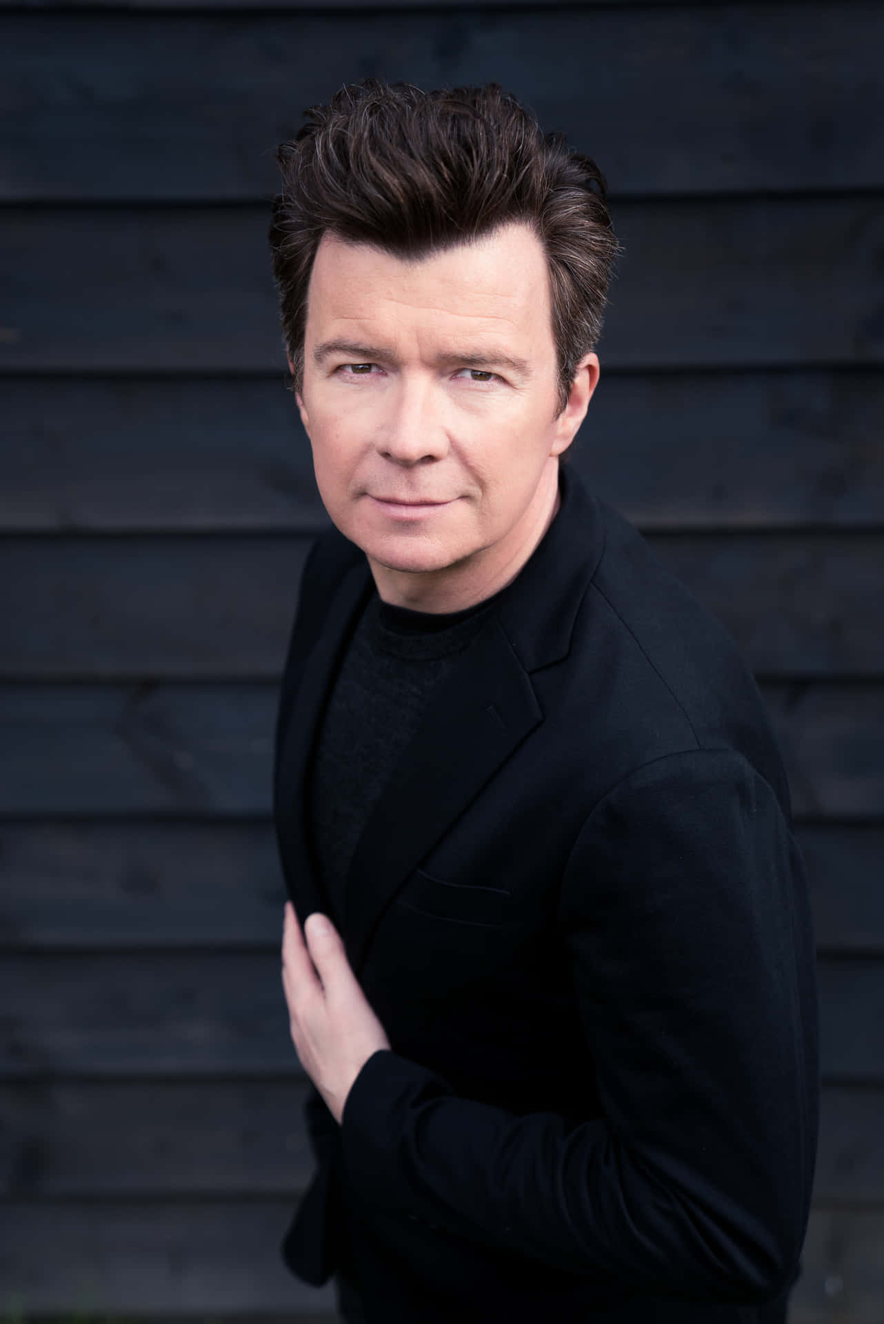 The Pop Star Rick Astley In His Signature Style. Background