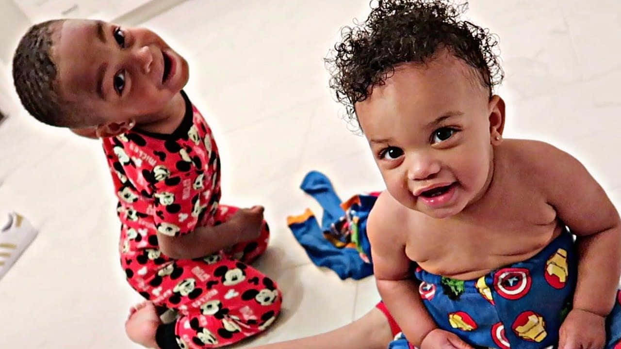 The Prince Family Radiating Joy And Love In A Playful Moment Background