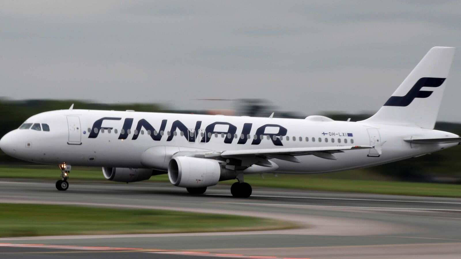 The Pristine Finnair Aircraft On The Runway Background