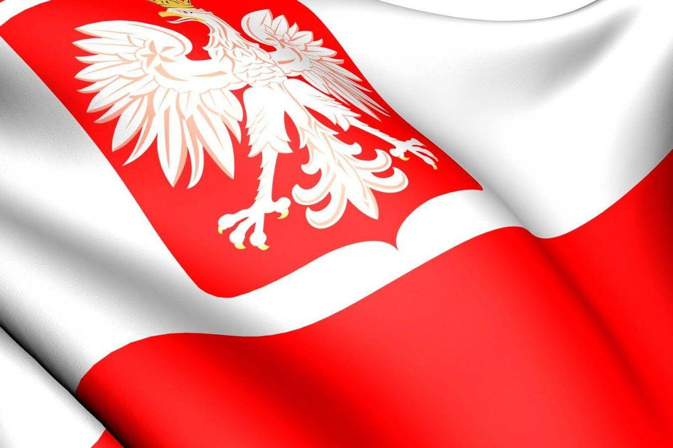 The Proud Polish Flag Fluttering In The Wind Against A Clear Blue Sky.