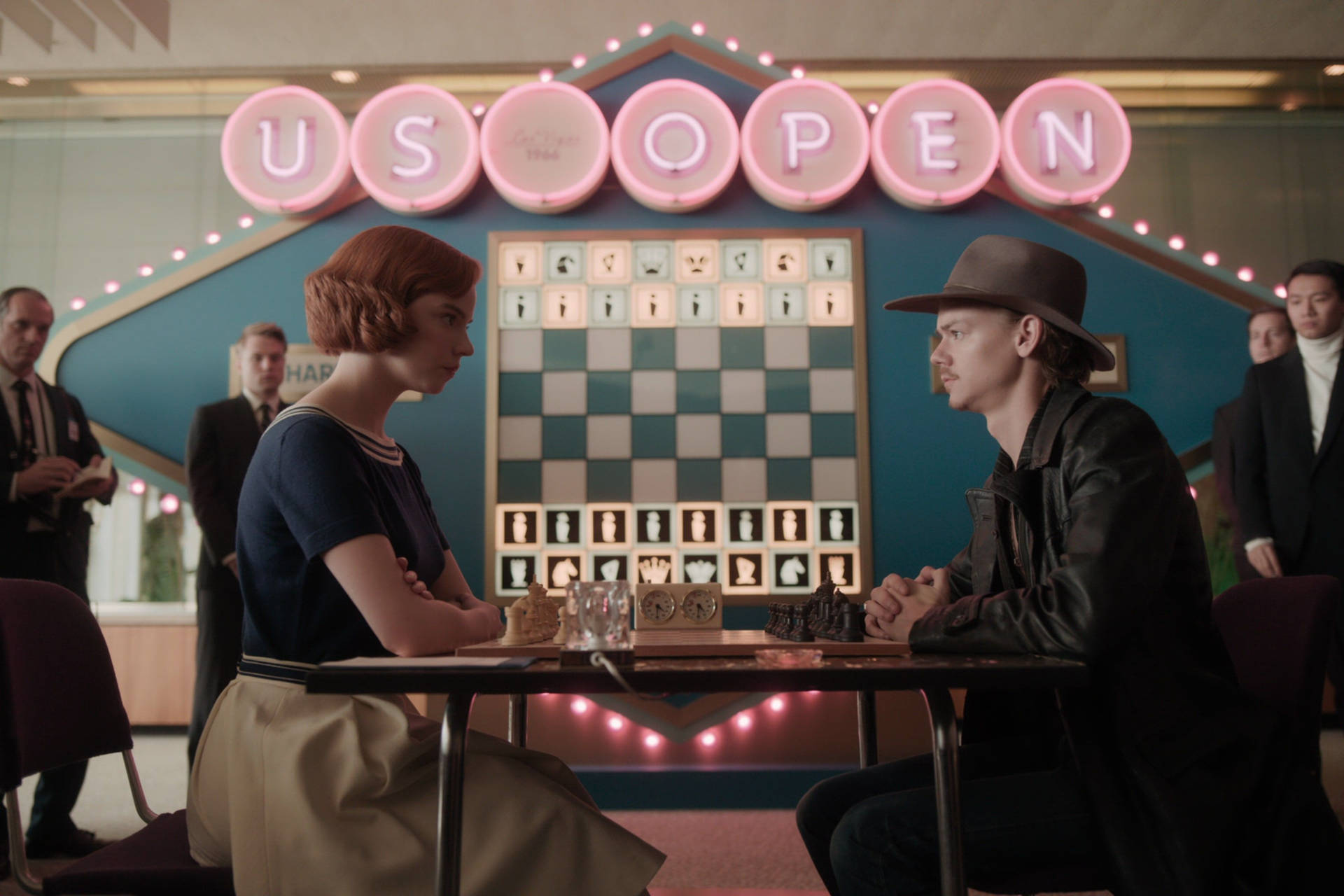 “the Queen’s Gambit: Beth Harmon Takes On Benny Watts In A Dramatic Chess Match.” Background
