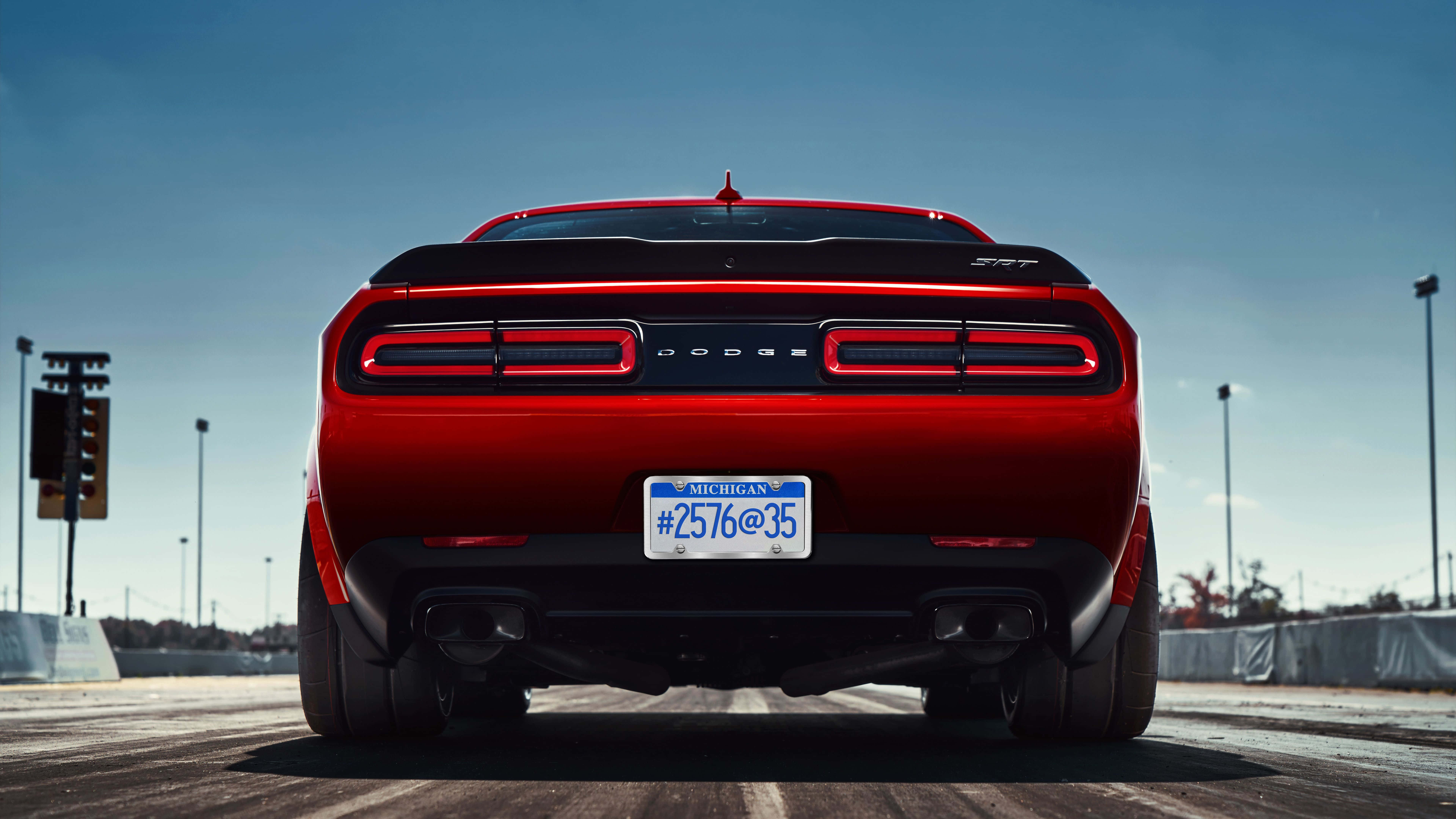 The Rear End Of A Red Dodge Challenger Background