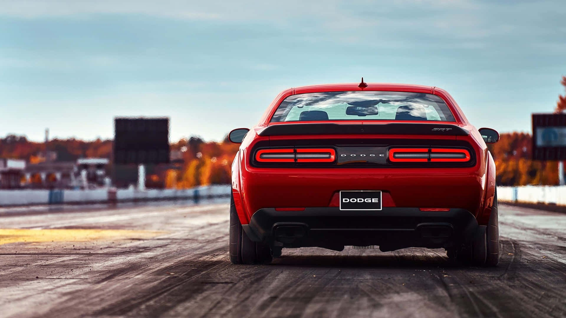 The Rear End Of A Red Dodge Challenger Background