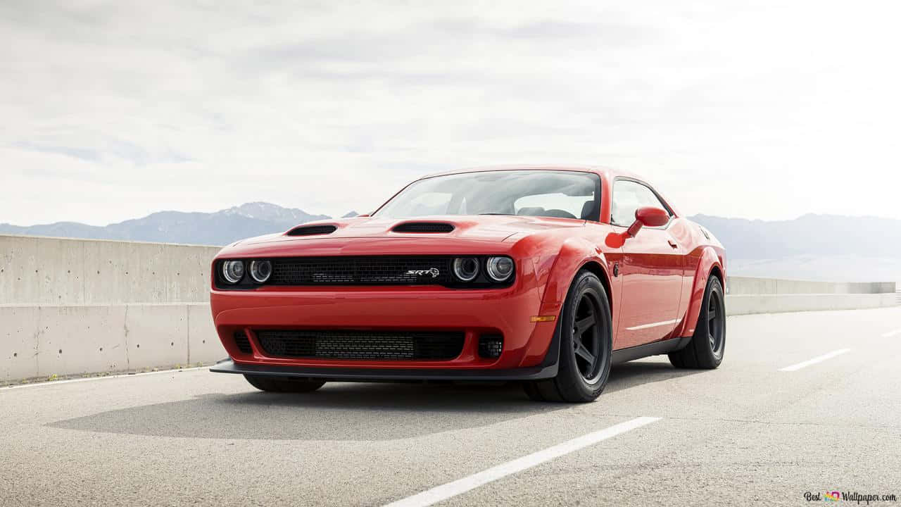 The Red Dodge Challenger Is Driving Down The Road Background