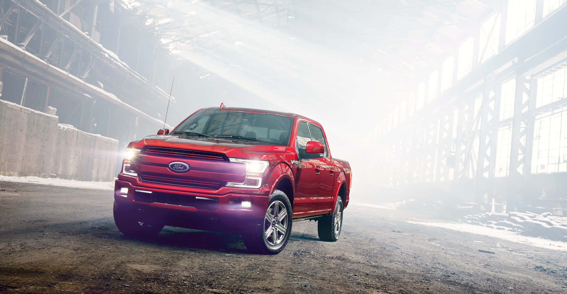 The Red Ford F-150 Is Driving Through An Industrial Building Background
