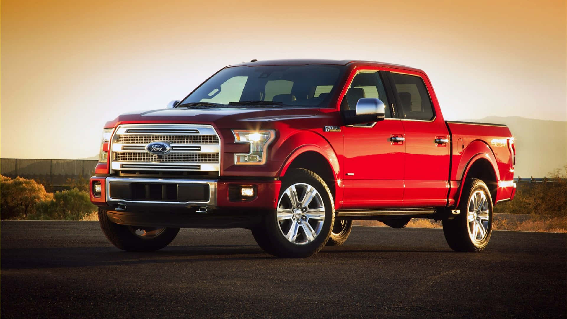 The Red Ford F - 150 Is Parked On A Desert Road Background