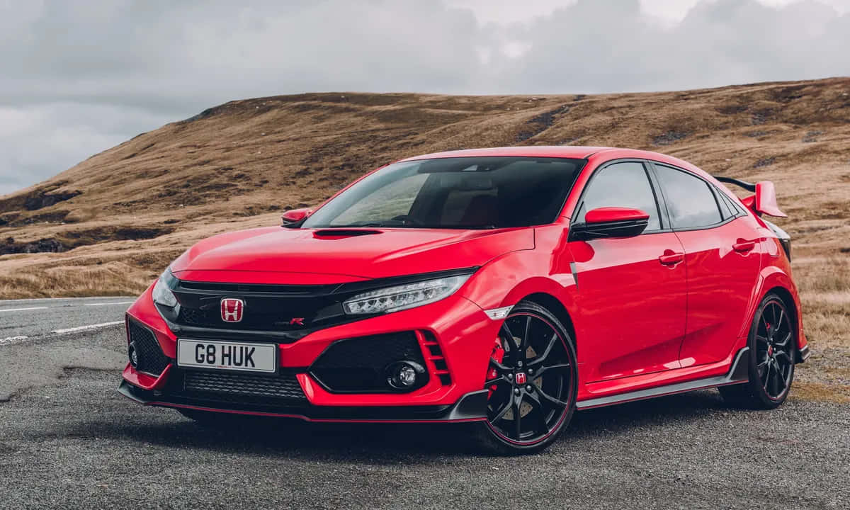 The Red Honda Civic Type R Is Parked On A Road