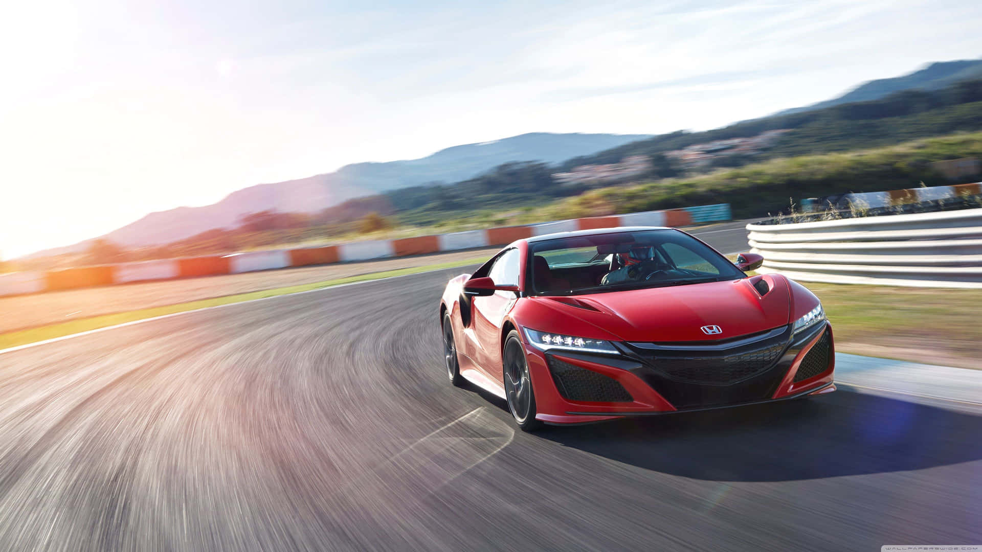 The Red Honda Nsx Is Driving On A Track Background