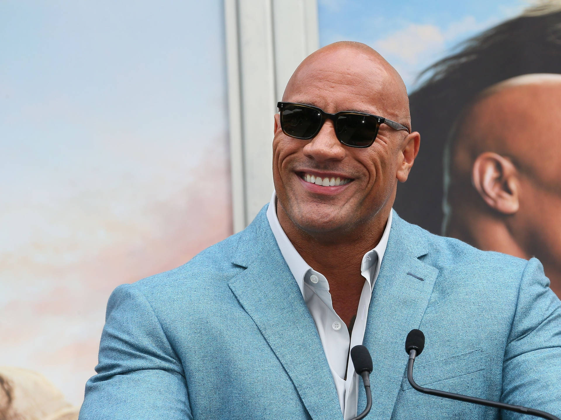 The Rock In Blue Suit Background