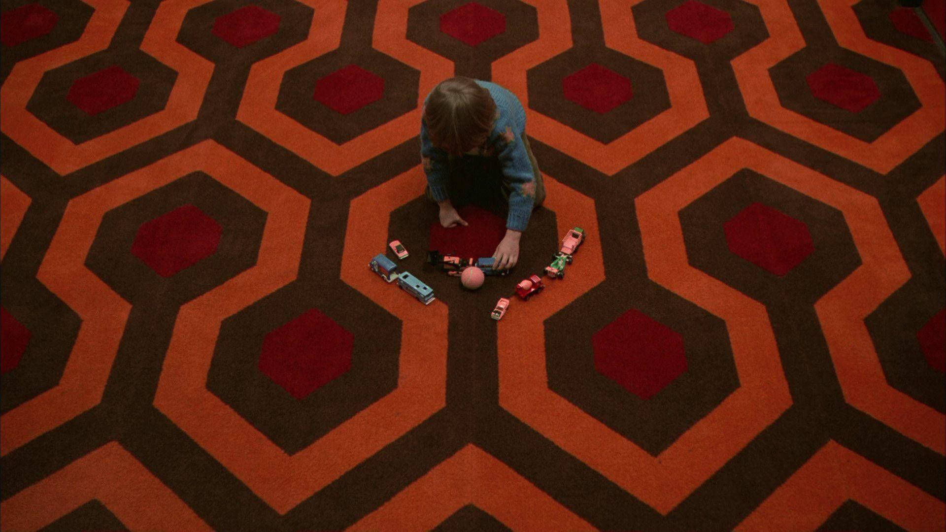 The Shining Danny Playing On Carpet Background