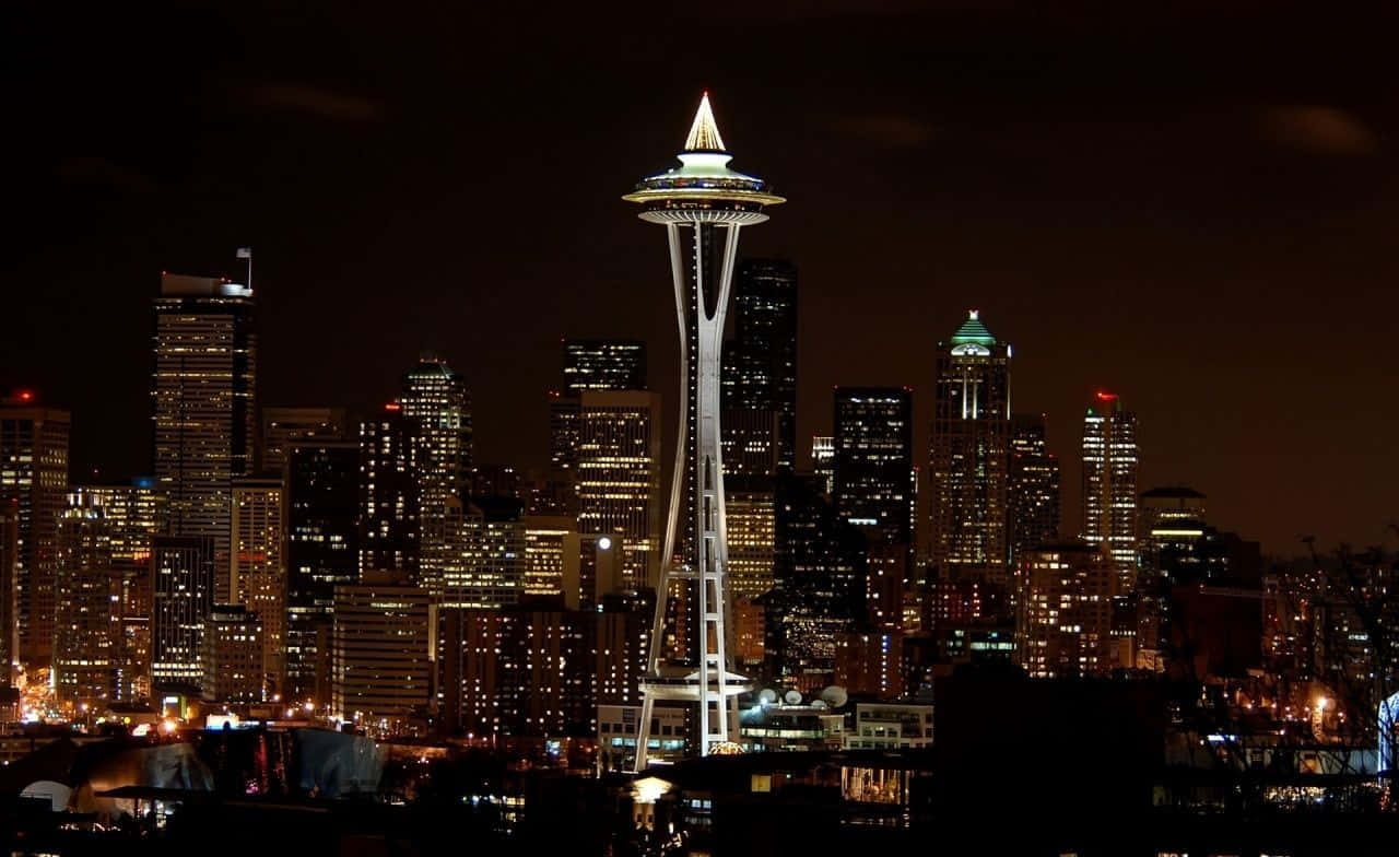 The Space Needle Is Lit Up At Night Background