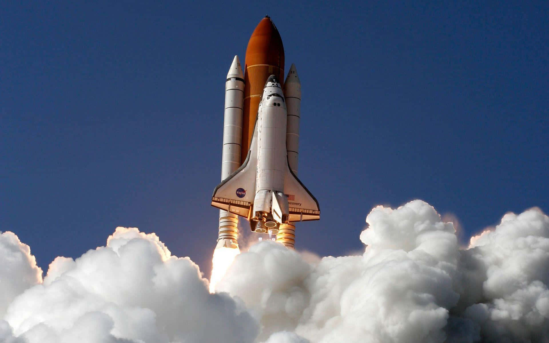 “the Space Shuttle Discovery Flies Through The Sky In A Bright And Sunny Day”