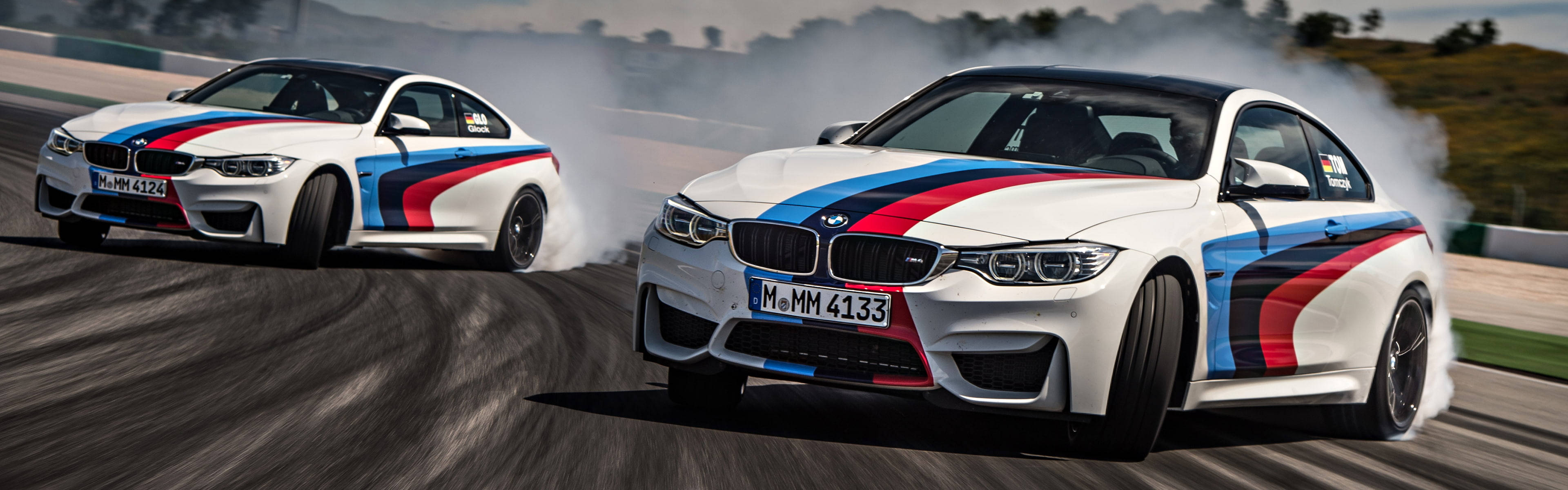 The Thrilling Ride Of A Bmw M4 Drift Car On The Track Background