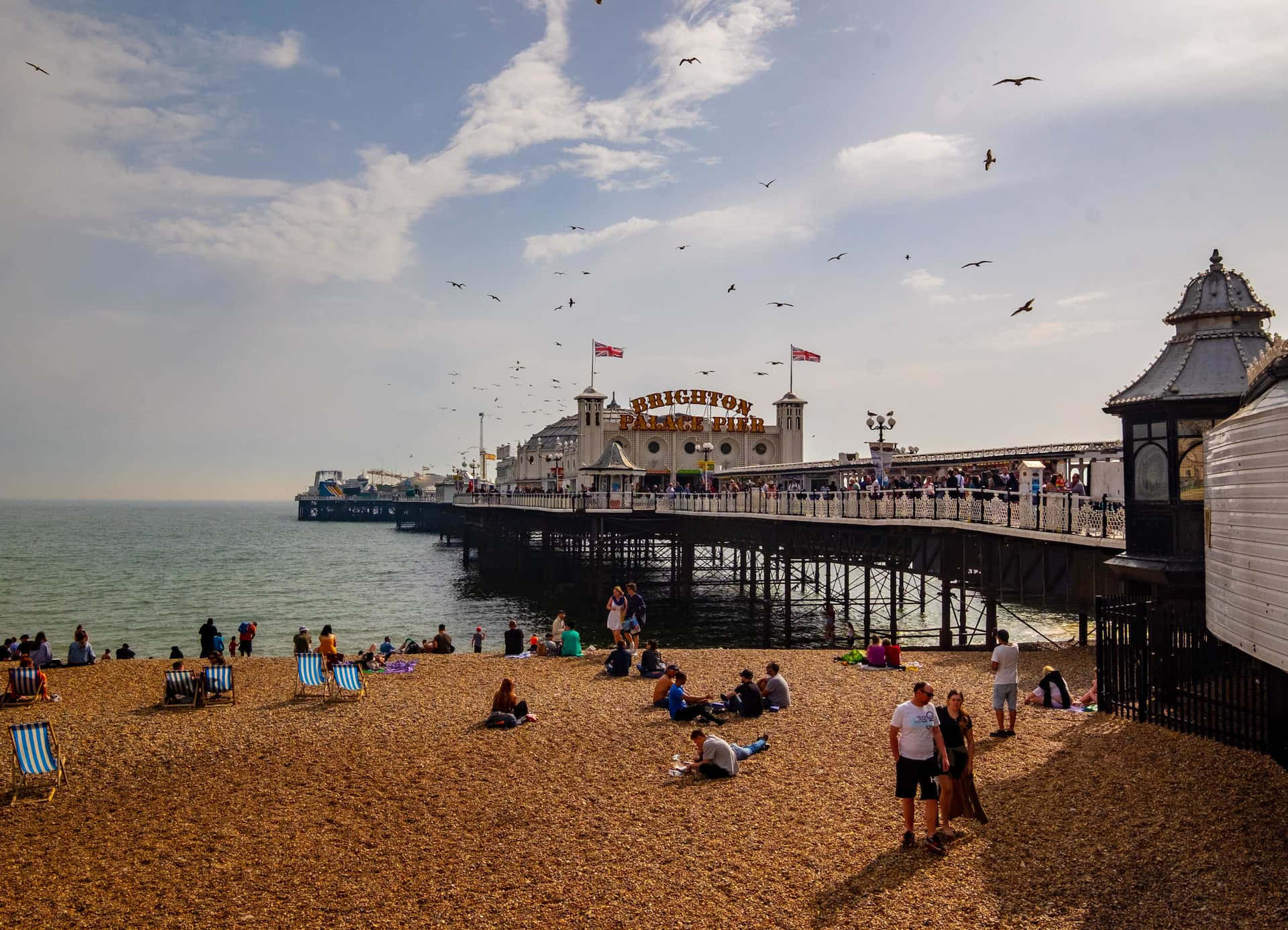 The Vibrant Brighton Pier At Sunset Background