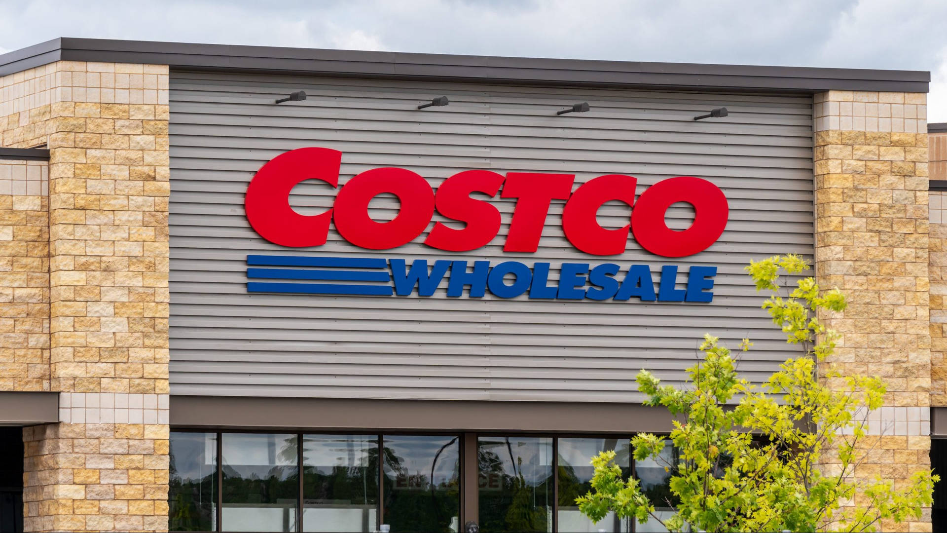 The Vibrant Exterior Of A Costco Wholesale Store Showcasing A Variety Of Plants. Background