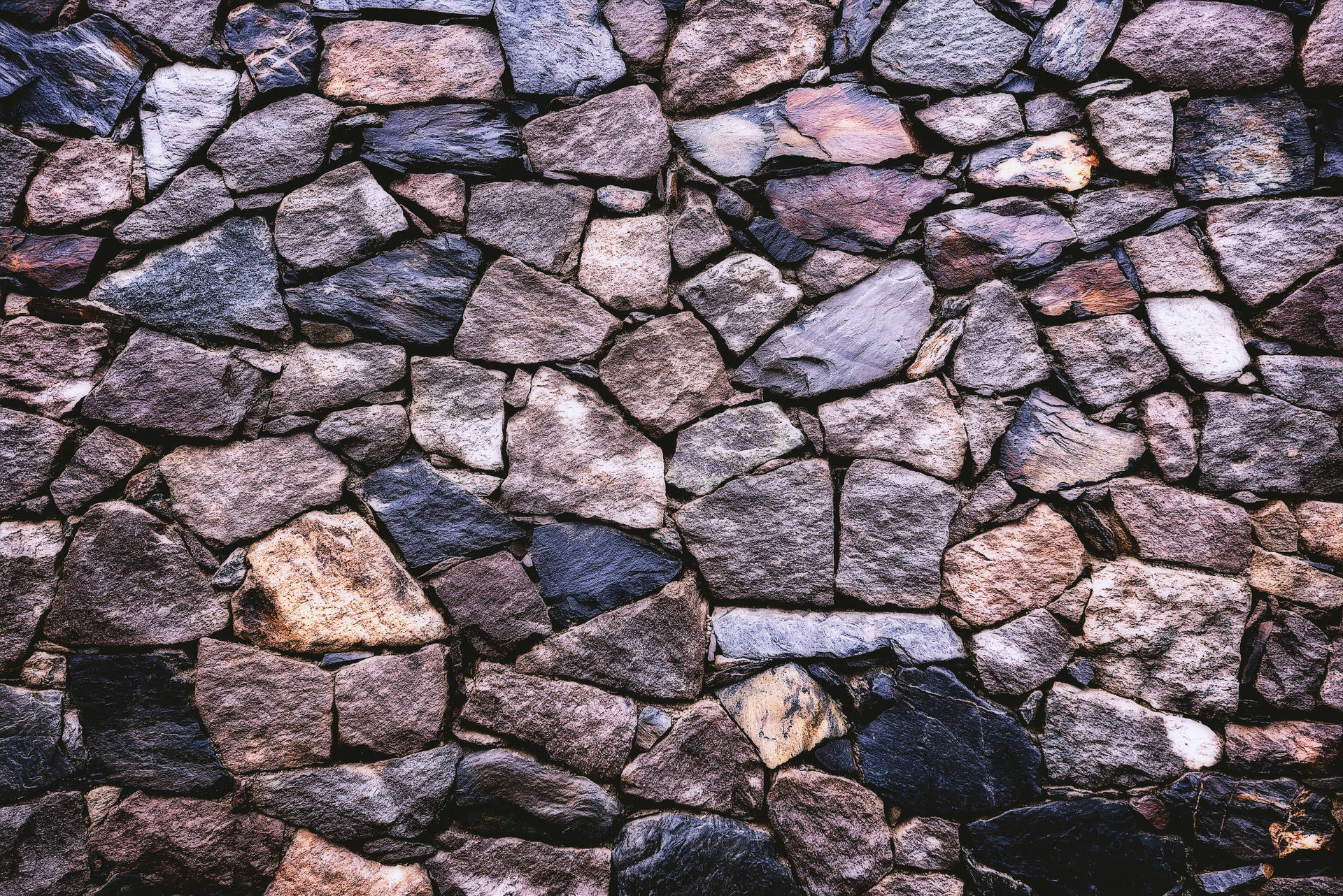 The Vibrant Palette Of A Stone Wall, Abundantly Rich In Color And Texture.