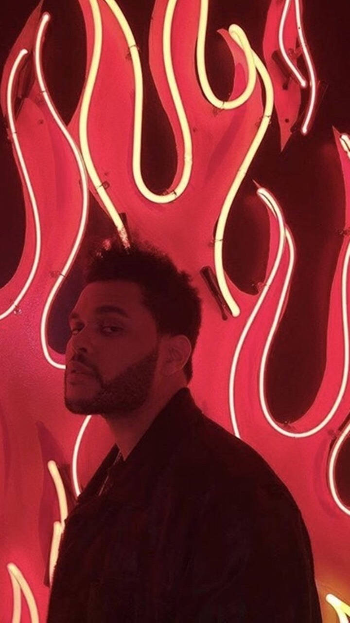 The Weeknd Posing In Red Flames Background