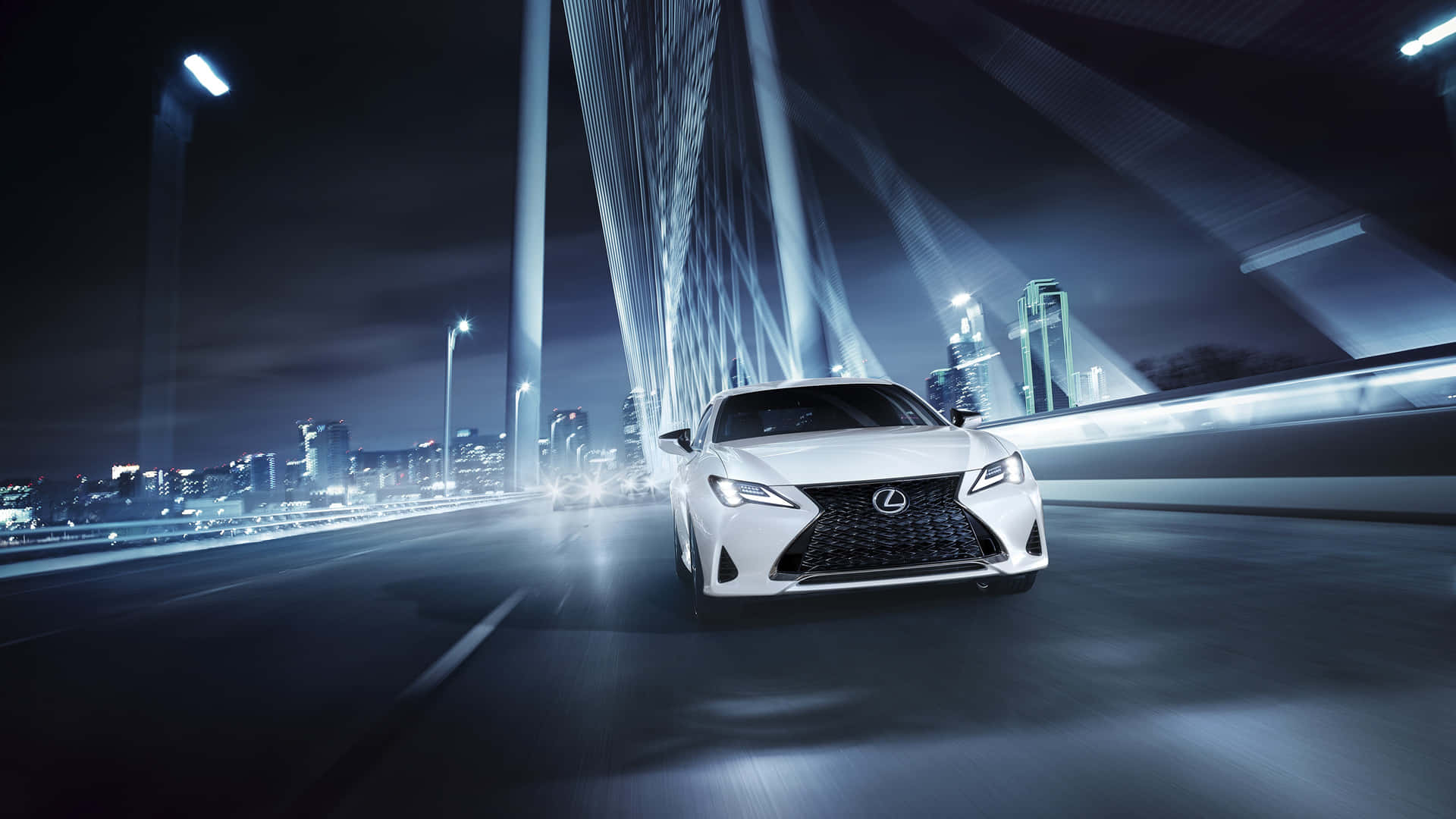 The White Lexus Cx Is Driving On A Bridge At Night