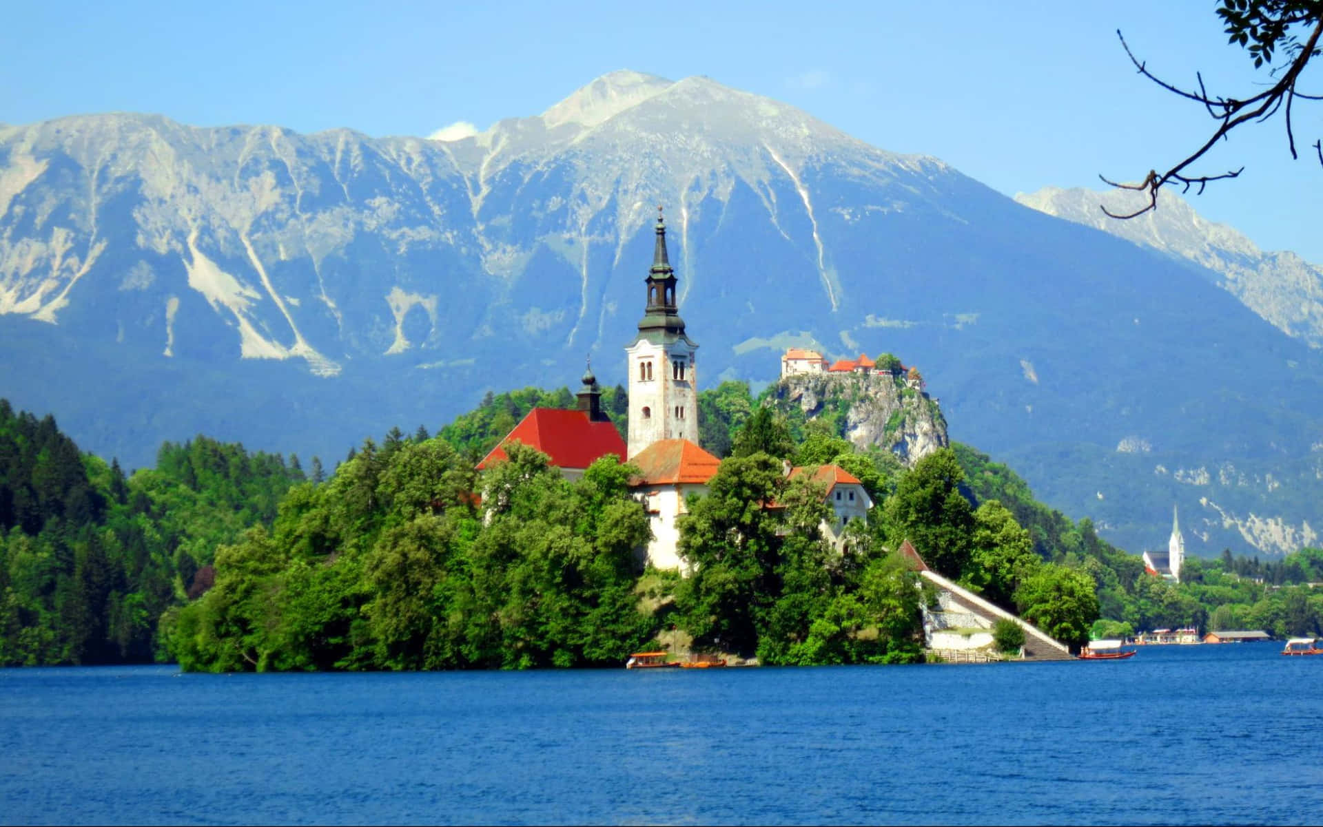 The White Peaks Of The Julian Alps Above Lake Bled Background
