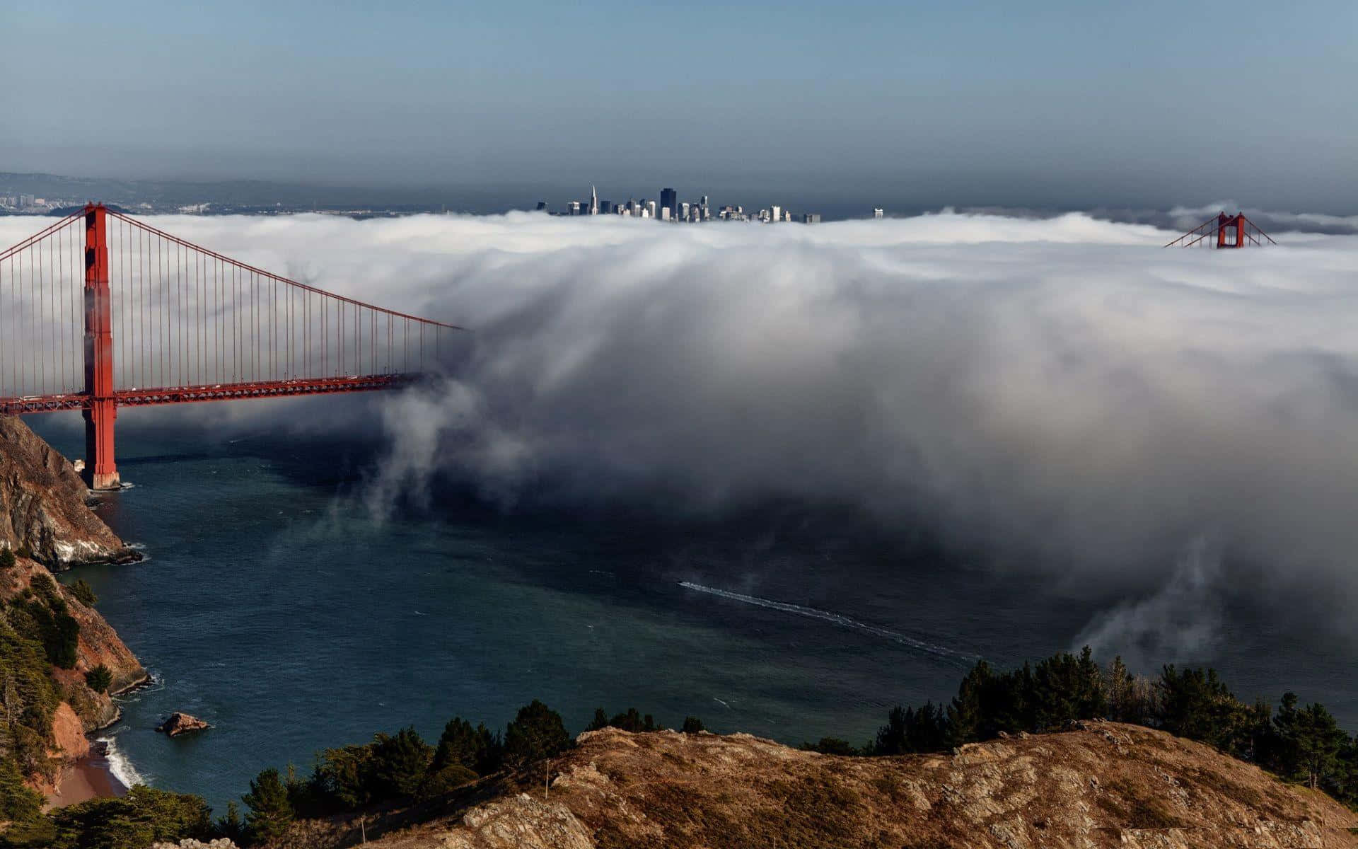 Thick Fog Rolling In Golden Gate Bridge Background