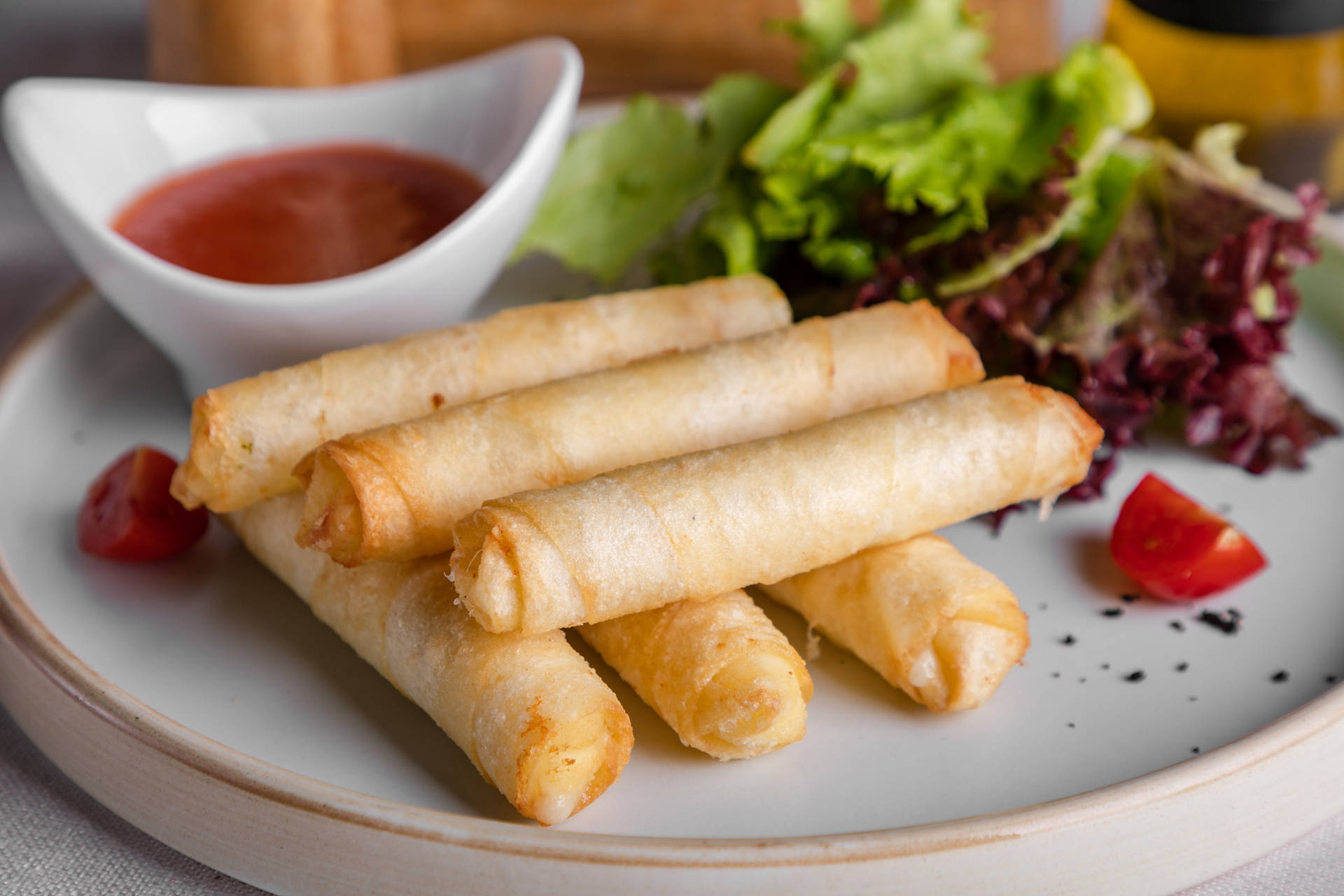 Thin Egg Rolls With Sauce And Lettuce Background