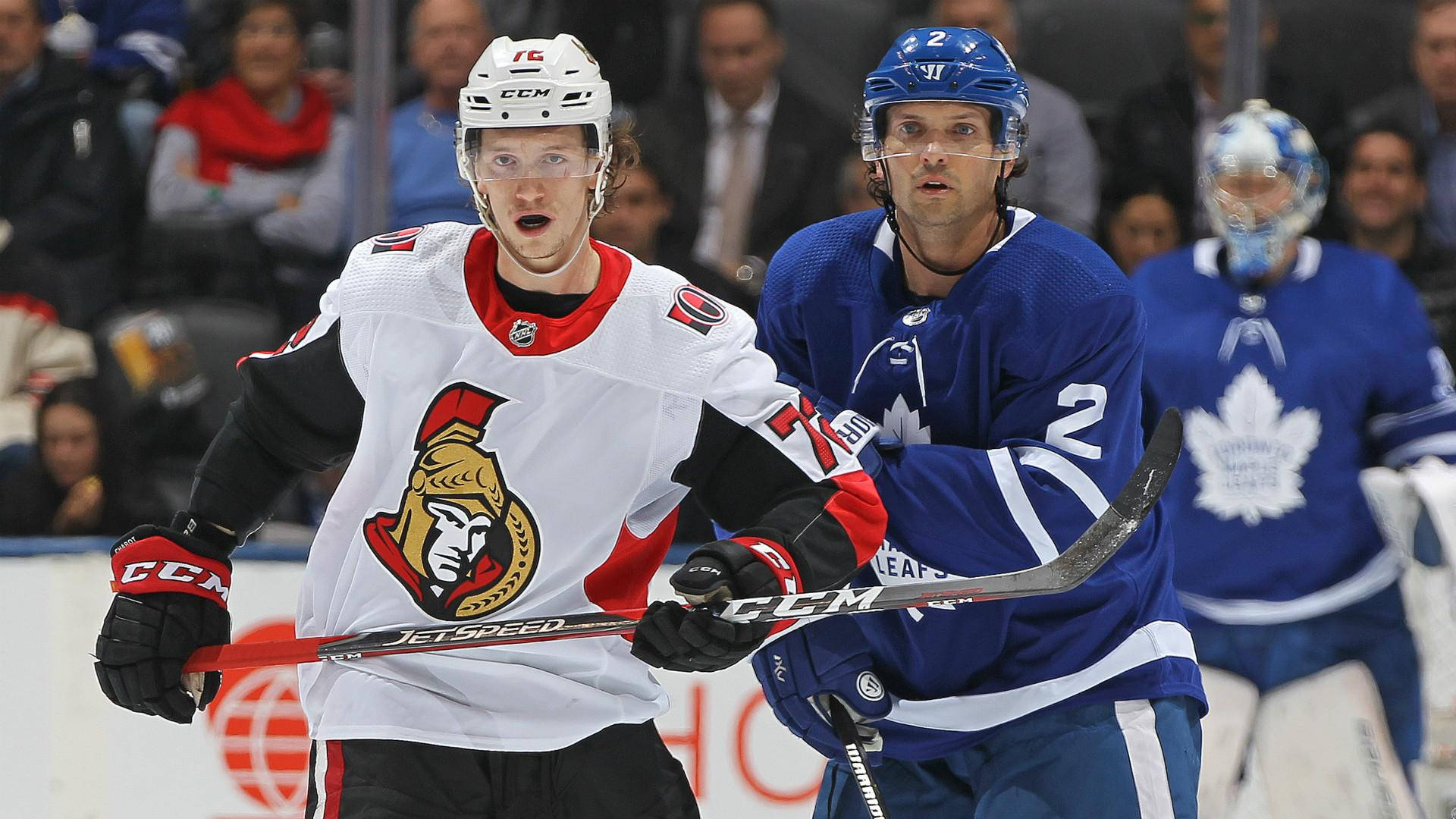 Thomas Chabot In Action Wearing Toronto Maple Leafs Jersey Background