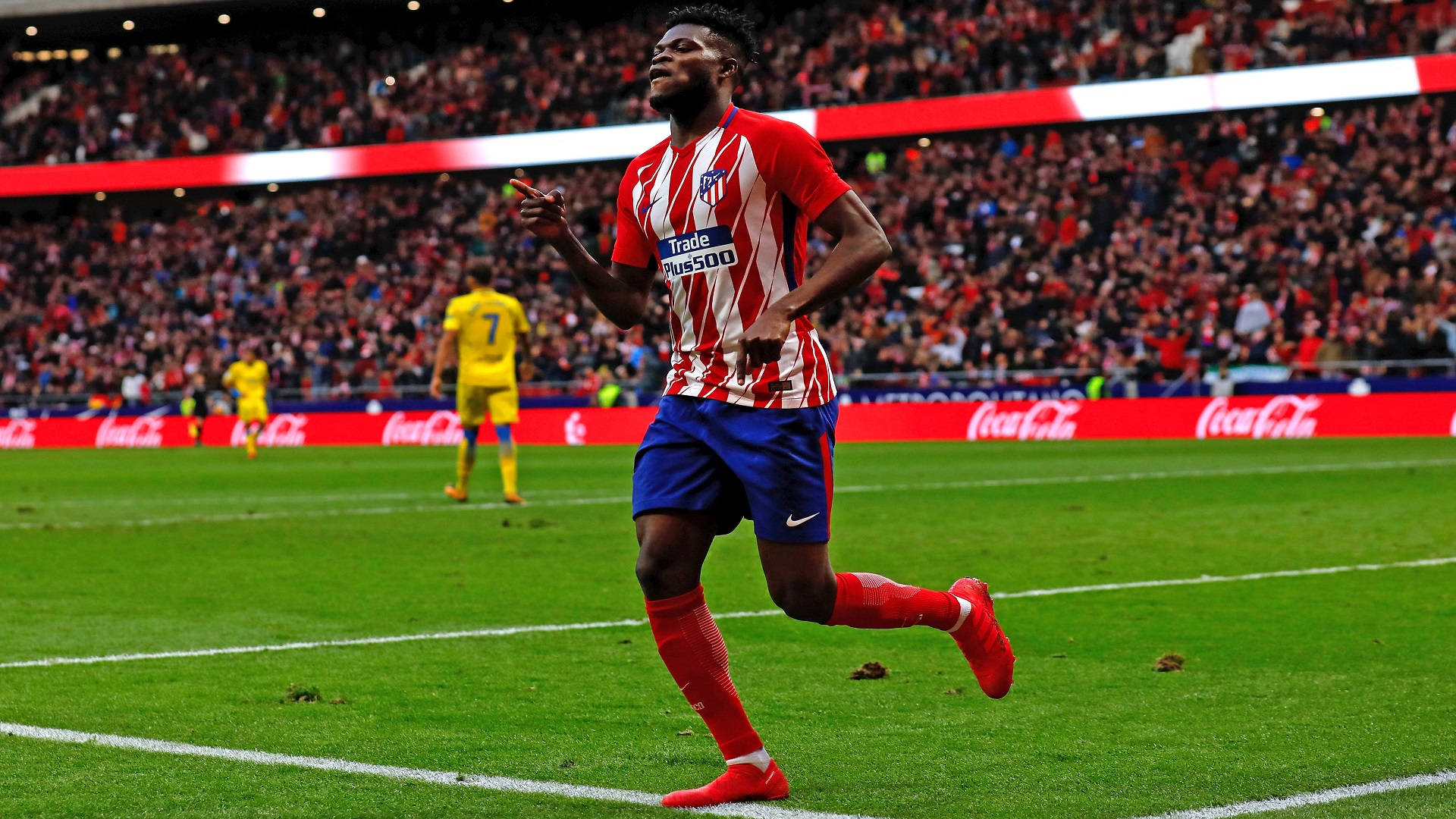 Thomas Partey Running Across A Green Field