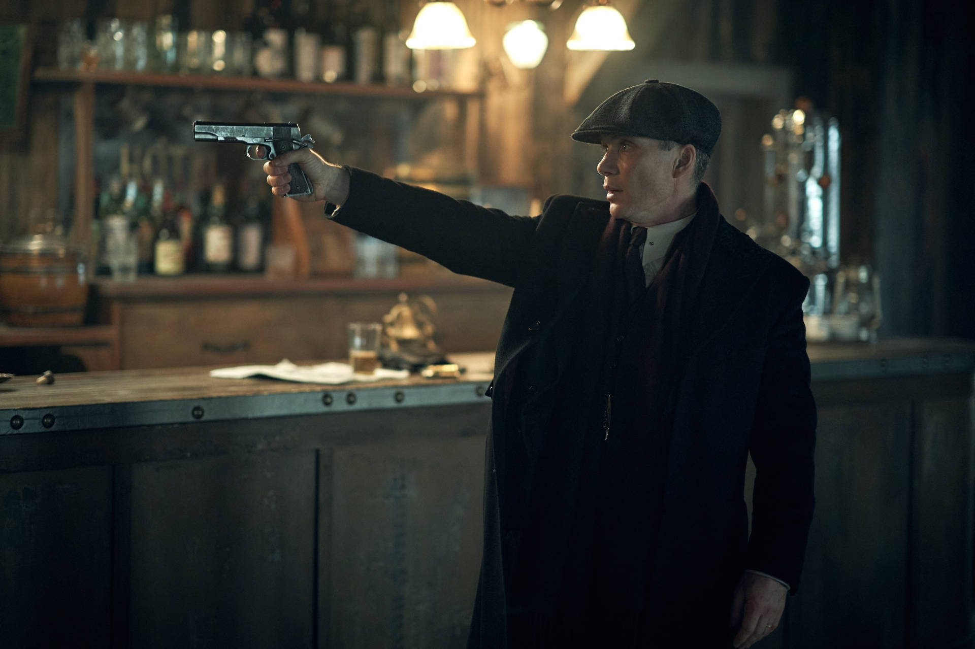 Thomas Shelby Holding A Gun Background