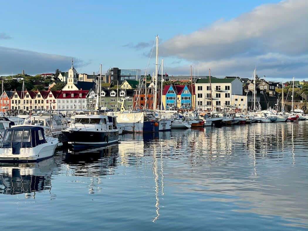 Thorshavn Boats On Calm Waters Background
