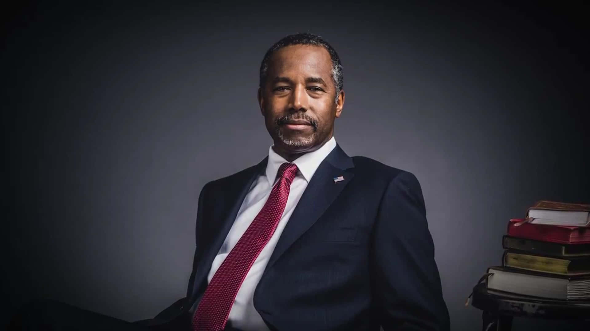 Thoughtful Ben Carson With His Remarkable Book Collections Background