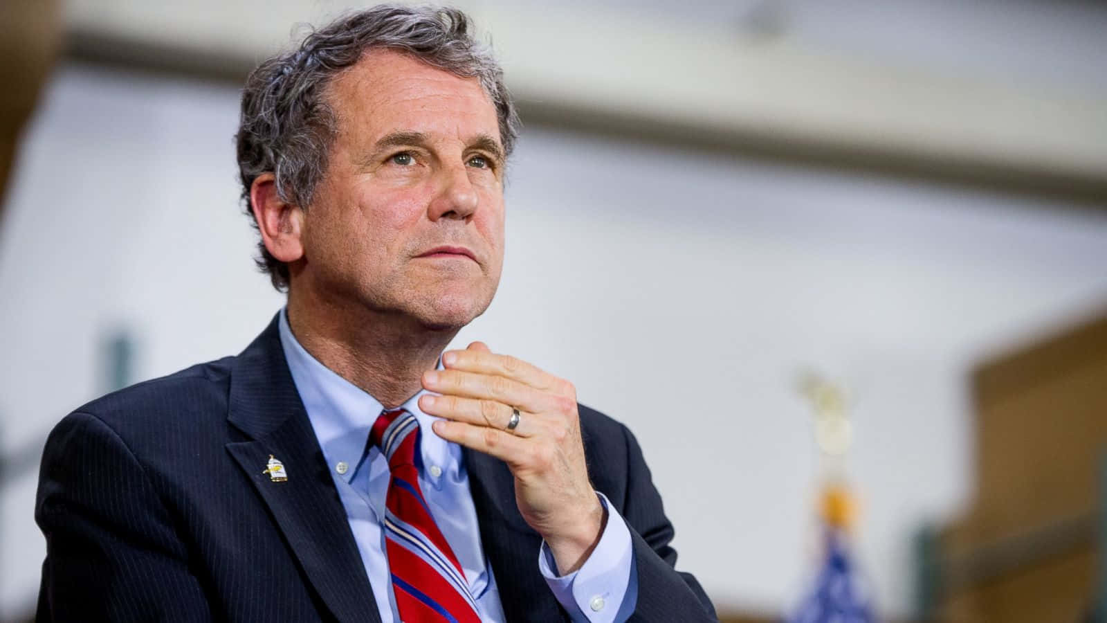 Thoughtful Sherrod Brown Scratching His Neck. Background