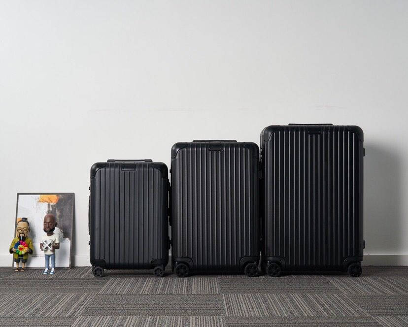 Three Black Rimowa Suitcases Background