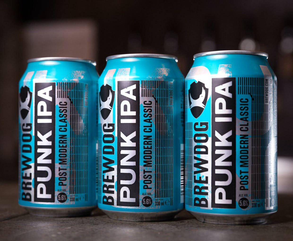 Three Brewdog Punk Ipa Beer Cans On Dark Backdrop Background