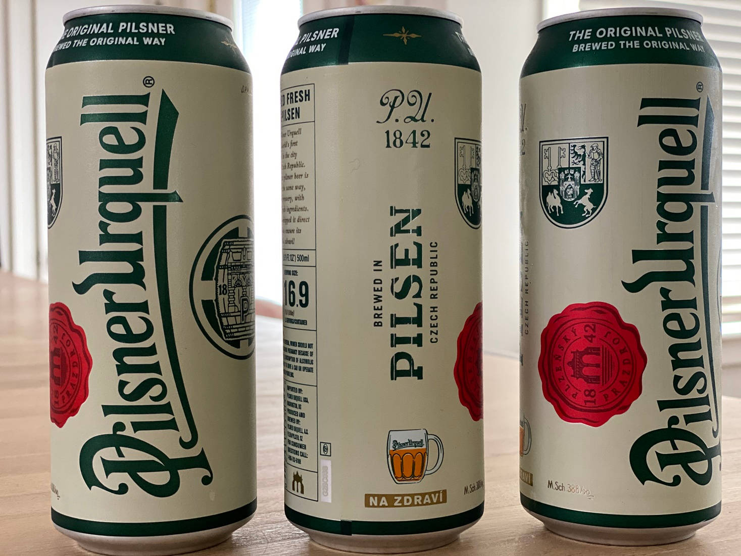 Three Can Of Pilsner Urquell Background