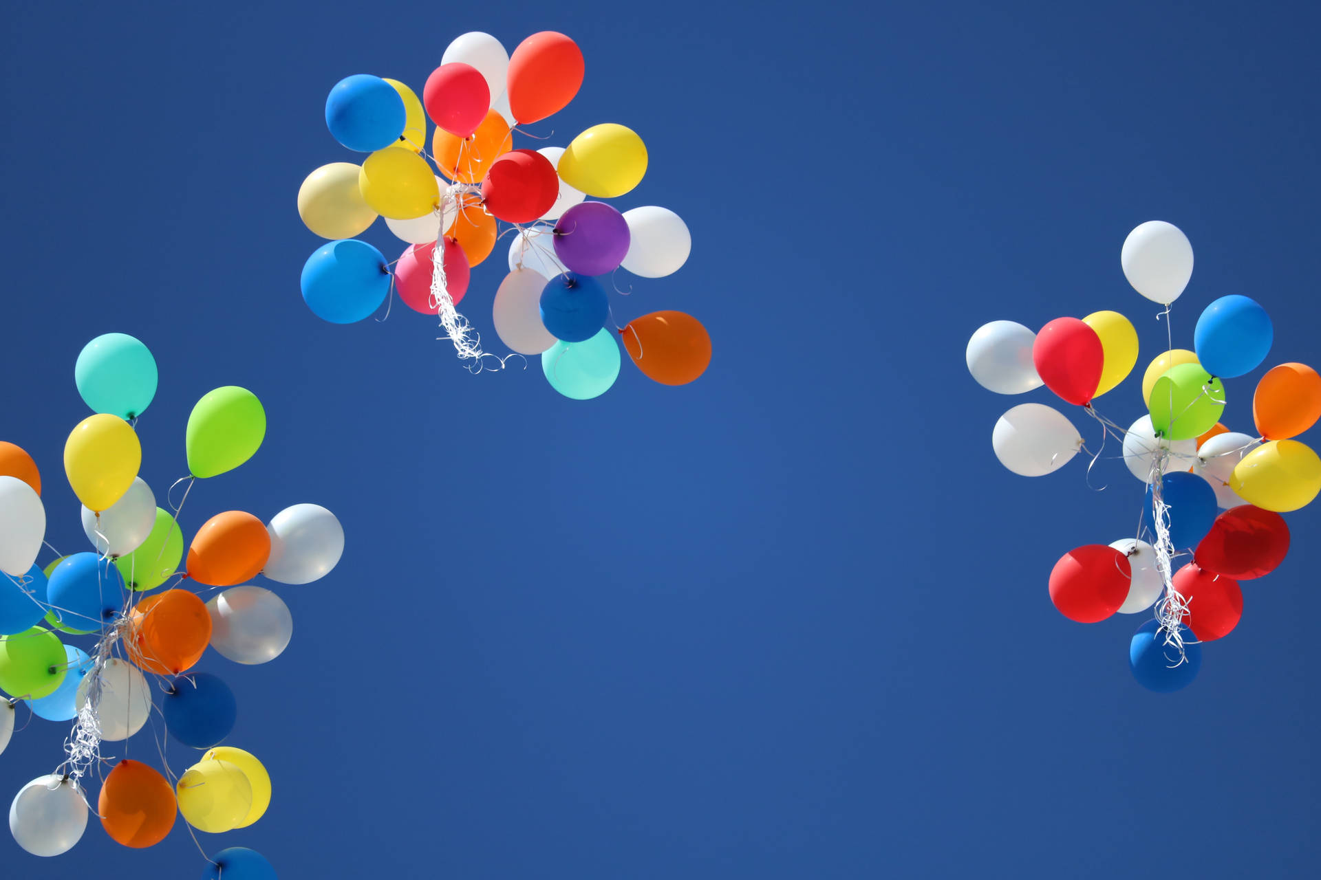 Three Cluster Balloons In Sky Background