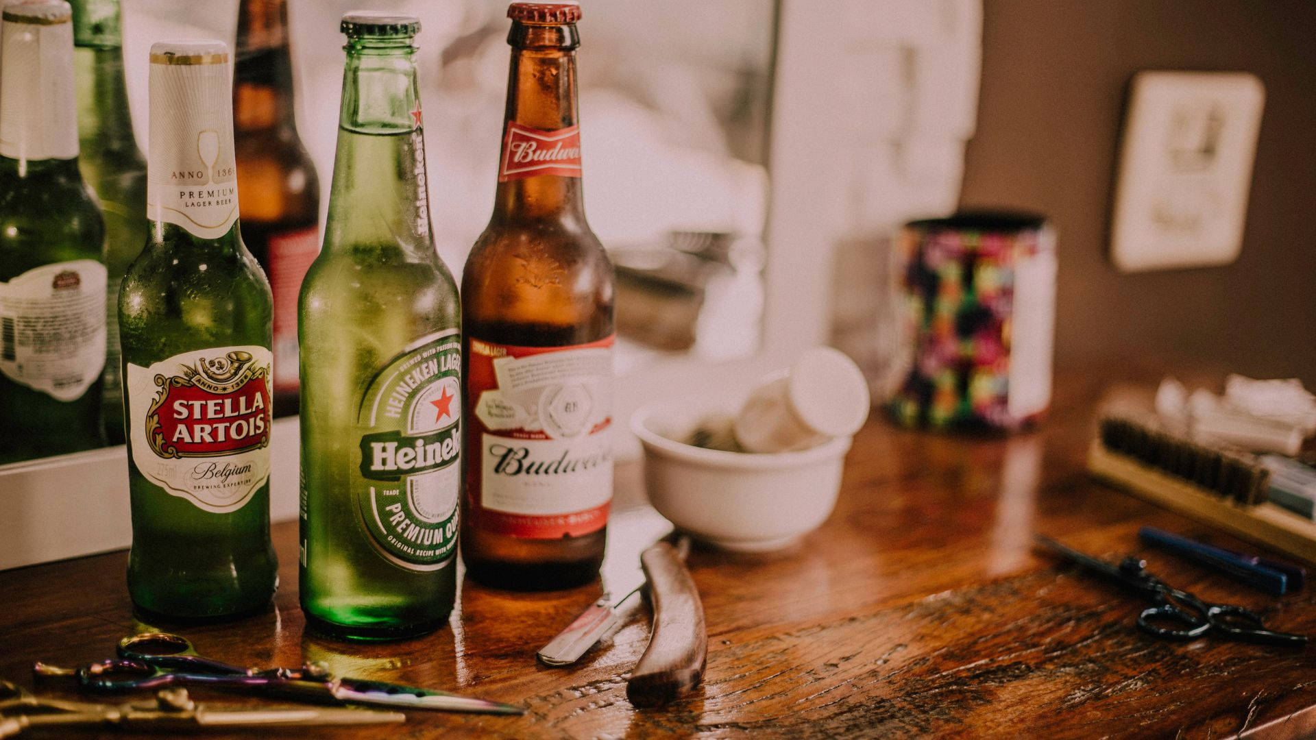 Three Different Alcohol Bottles Against A Mirror