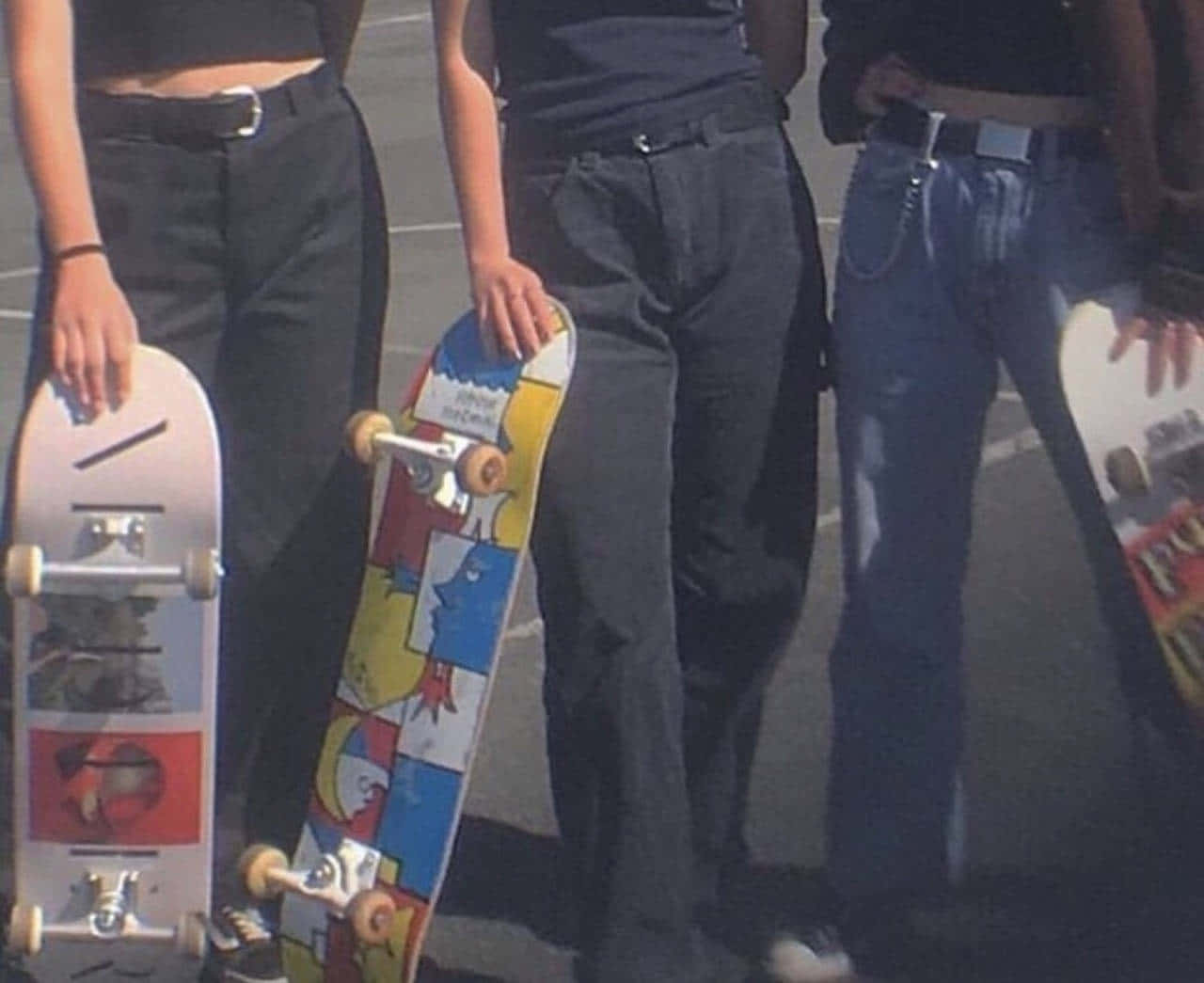 Three Girls Standing With Skateboards