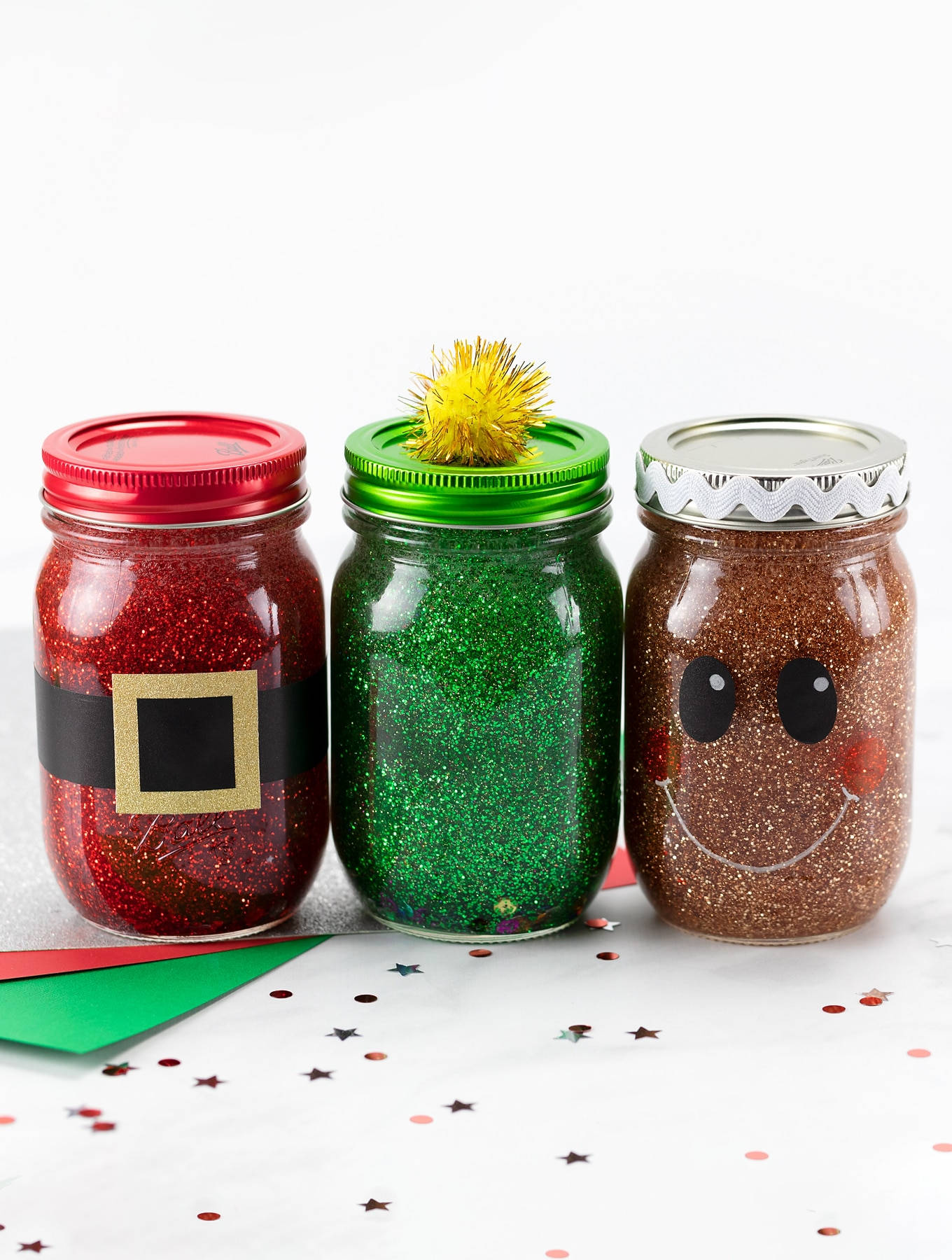 Three Mason Jars With Glitter And Santa Claus