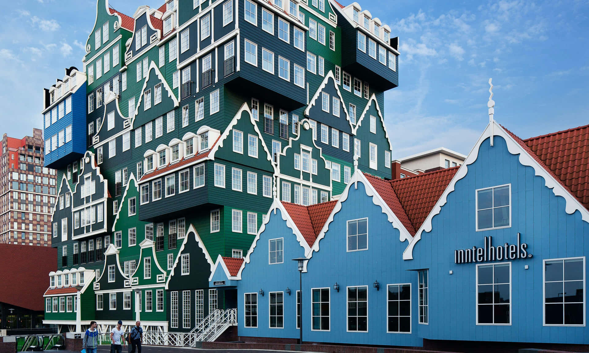 Three Men In Front Of Inntel Hotel Zaandam Background