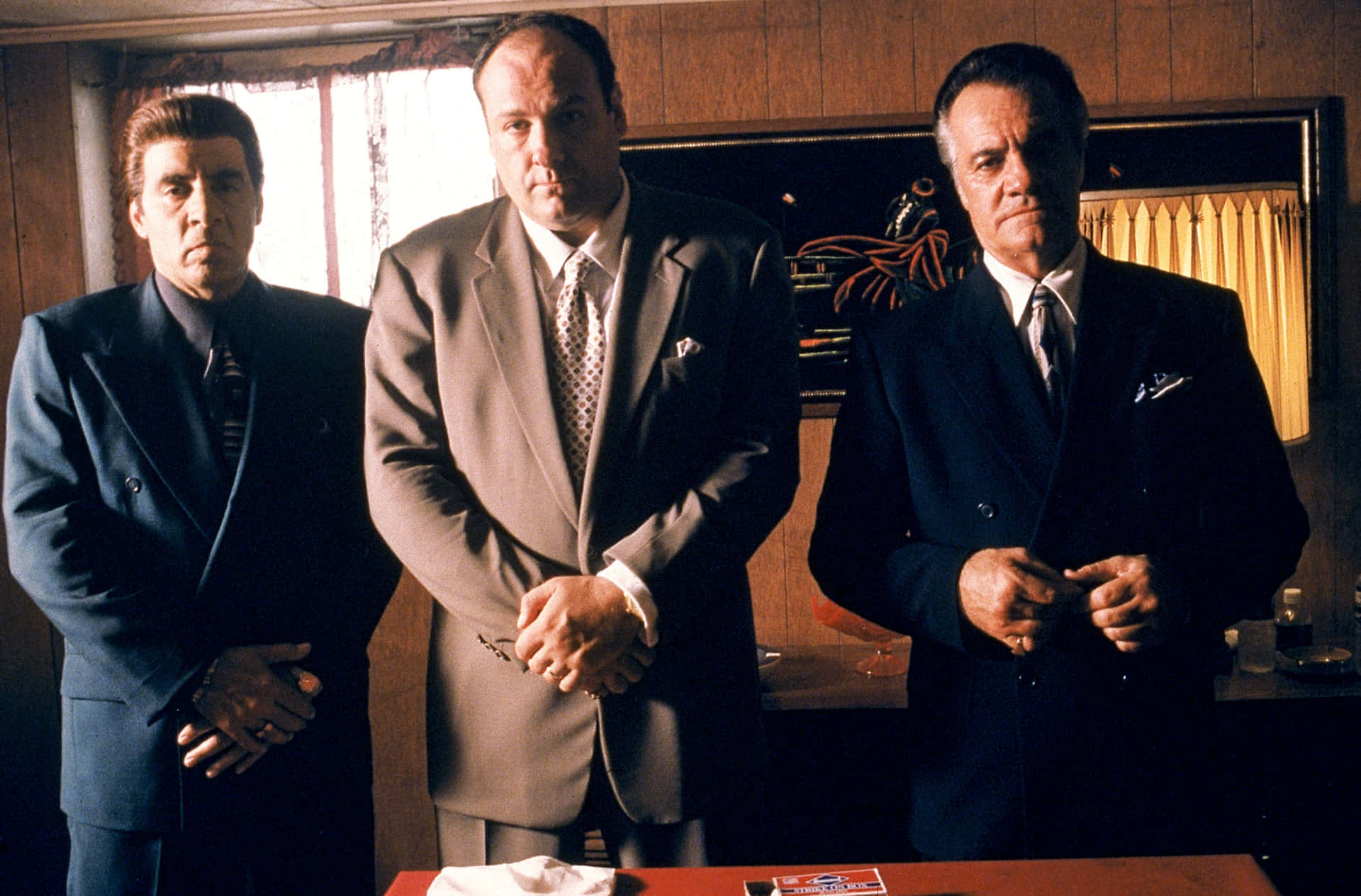 Three Men Standing In Front Of A Table Background