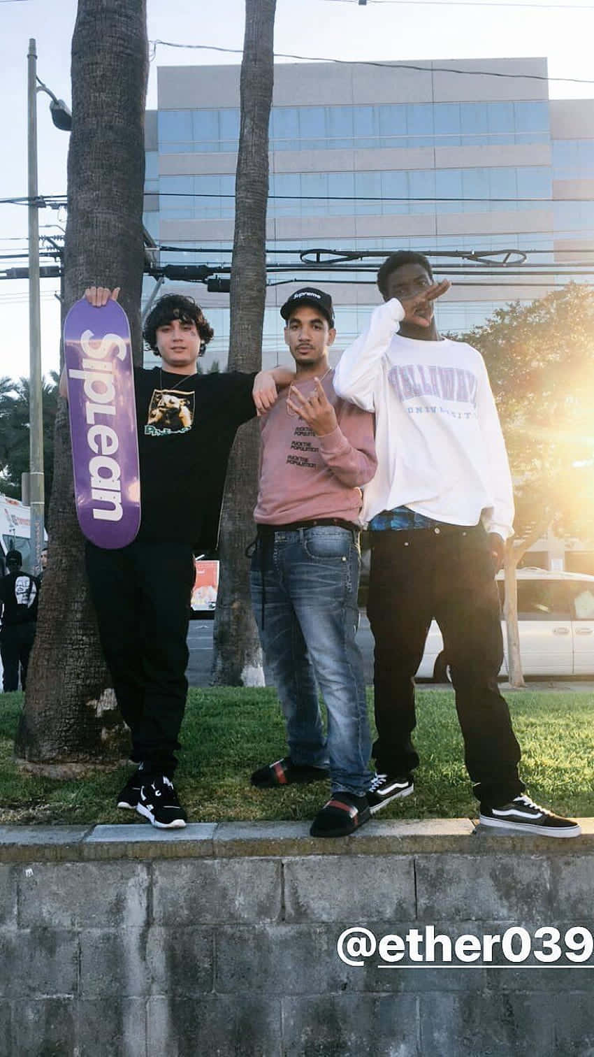 Three Men Standing Next To A Wall Background