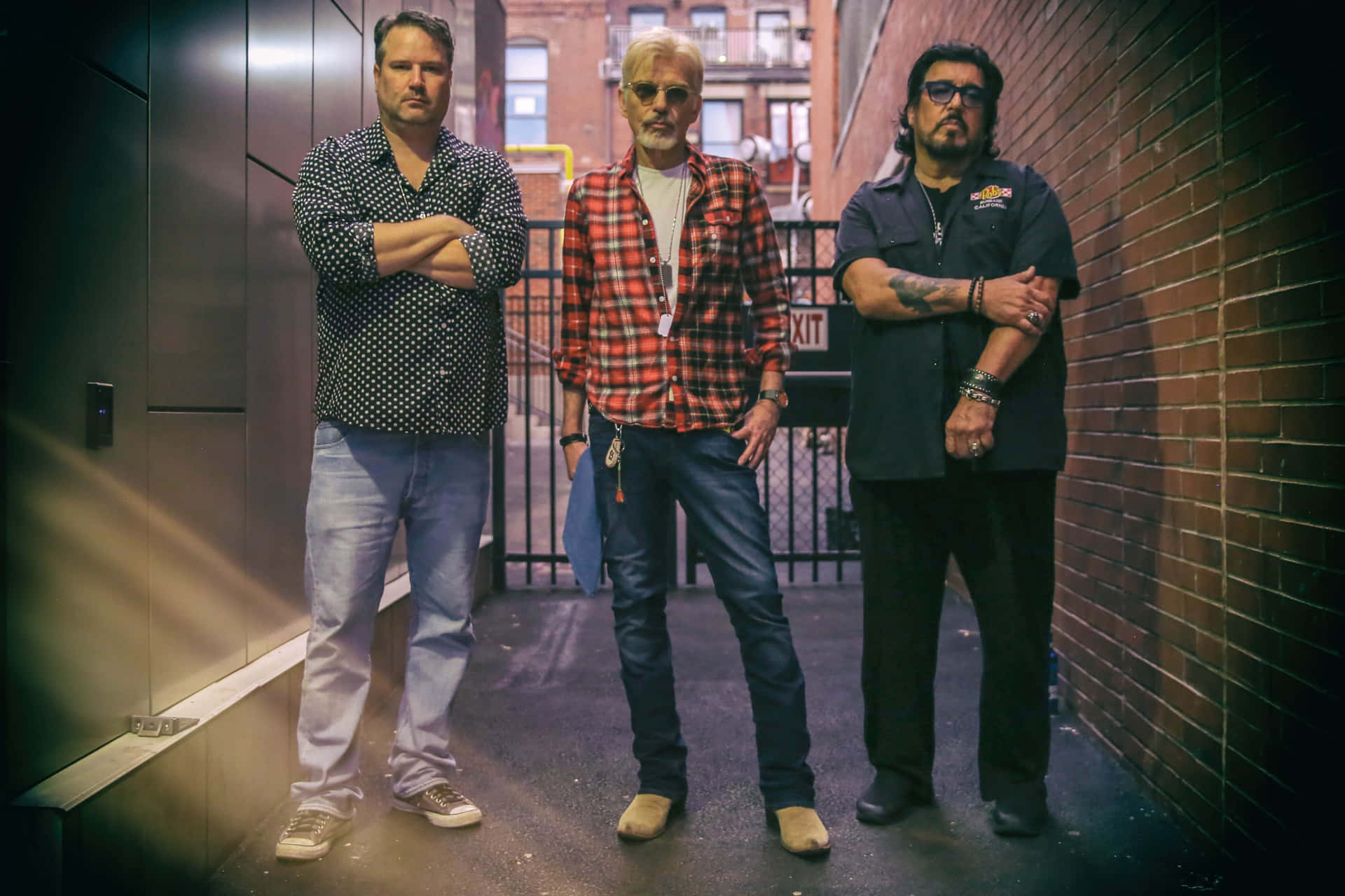 Three Men Standingin Alley Background