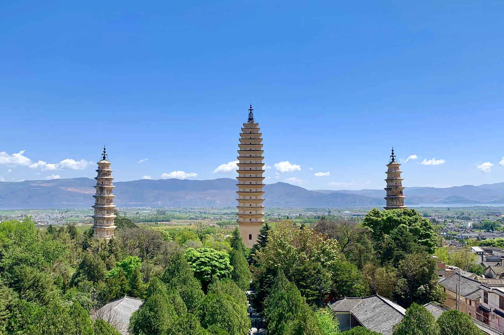 Three Pagodas During Daytime Background